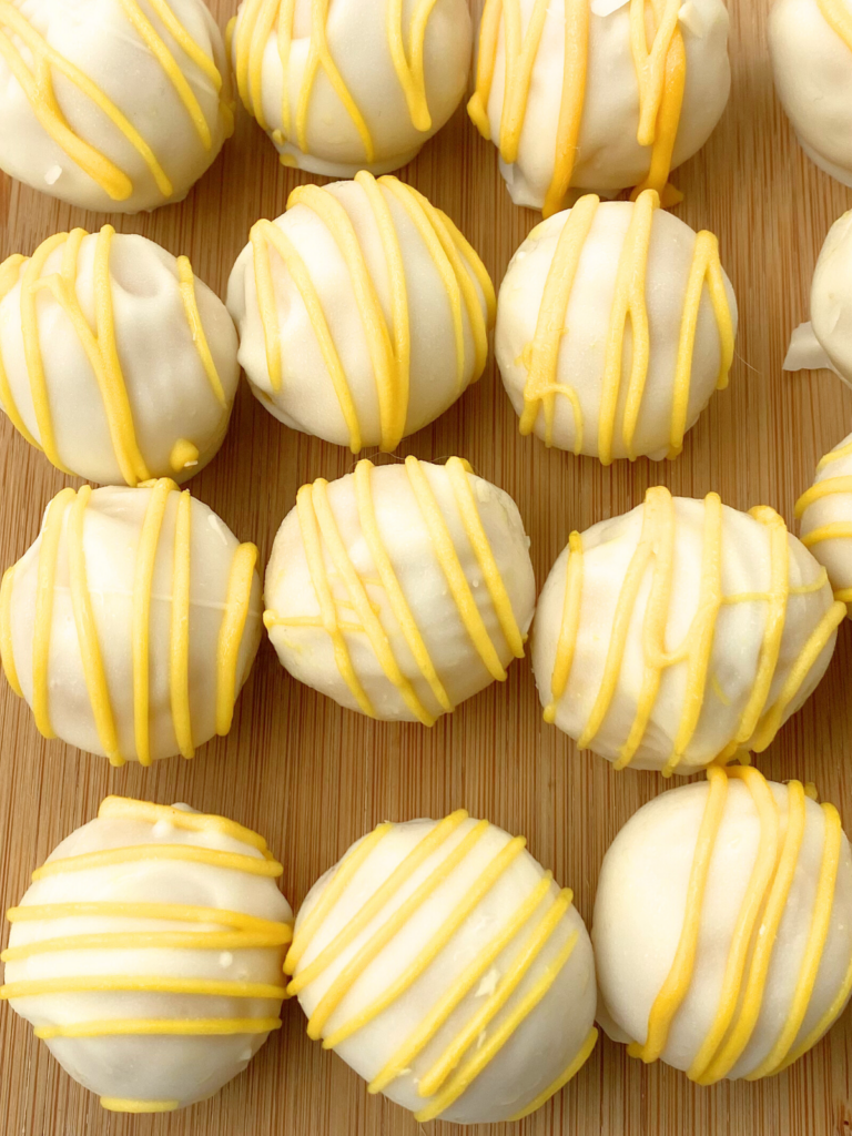 lemon oreo balls on a wooden tray