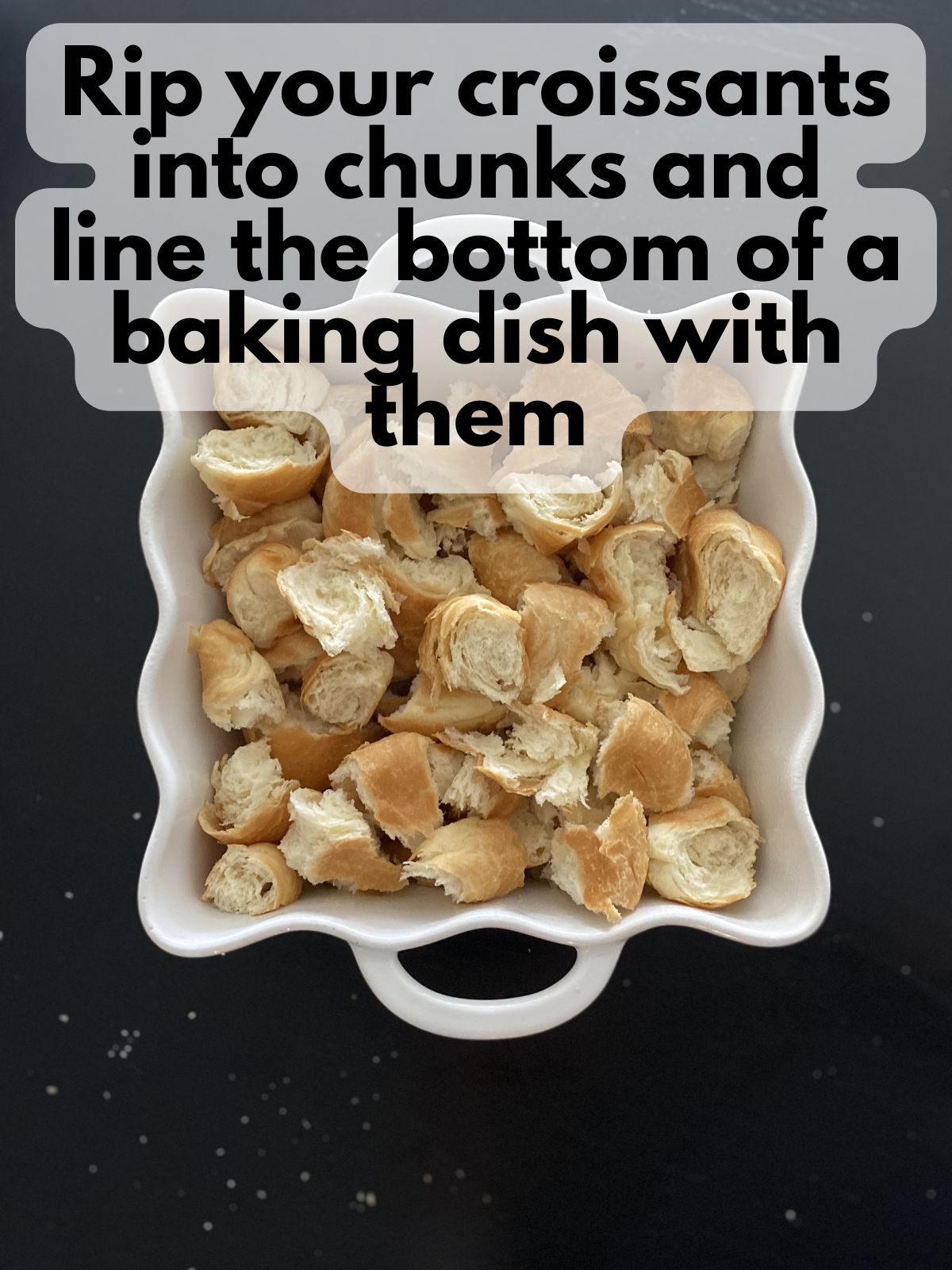 croissant pieces ripped into chunks in a baking dish