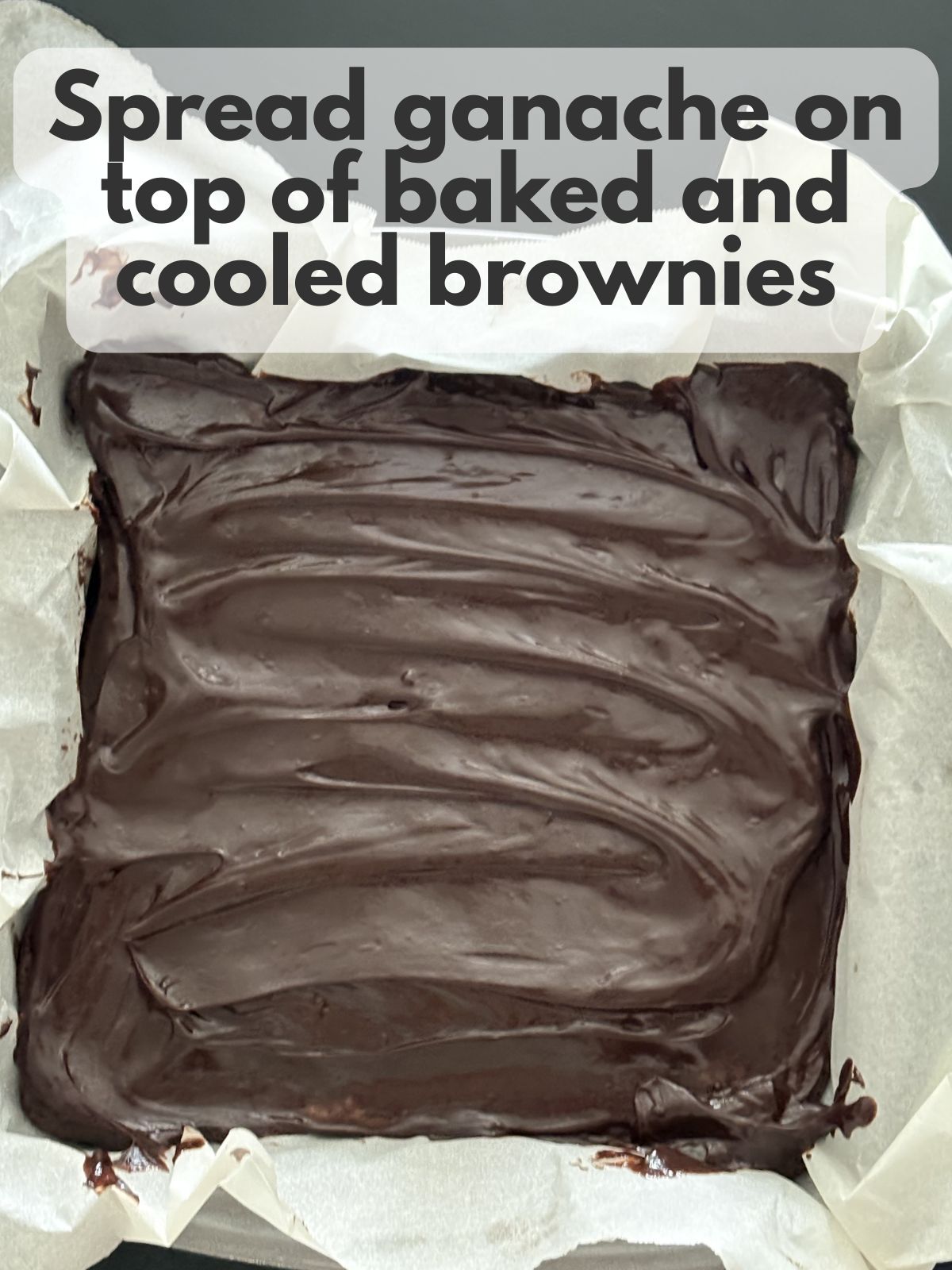 chocolate ganache spread over bake brownies