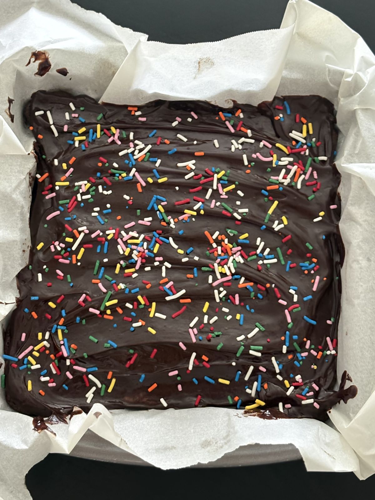 sprinkles on top of wet chocolate ganache