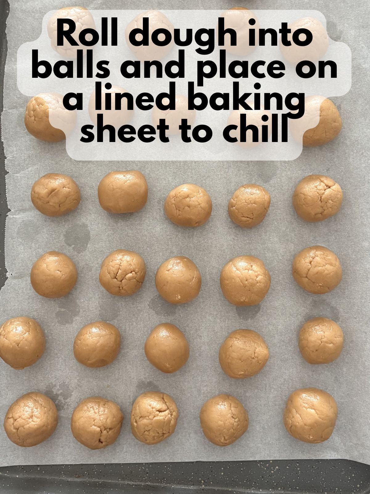 cookie butter dough rolled into balls on a baking sheet