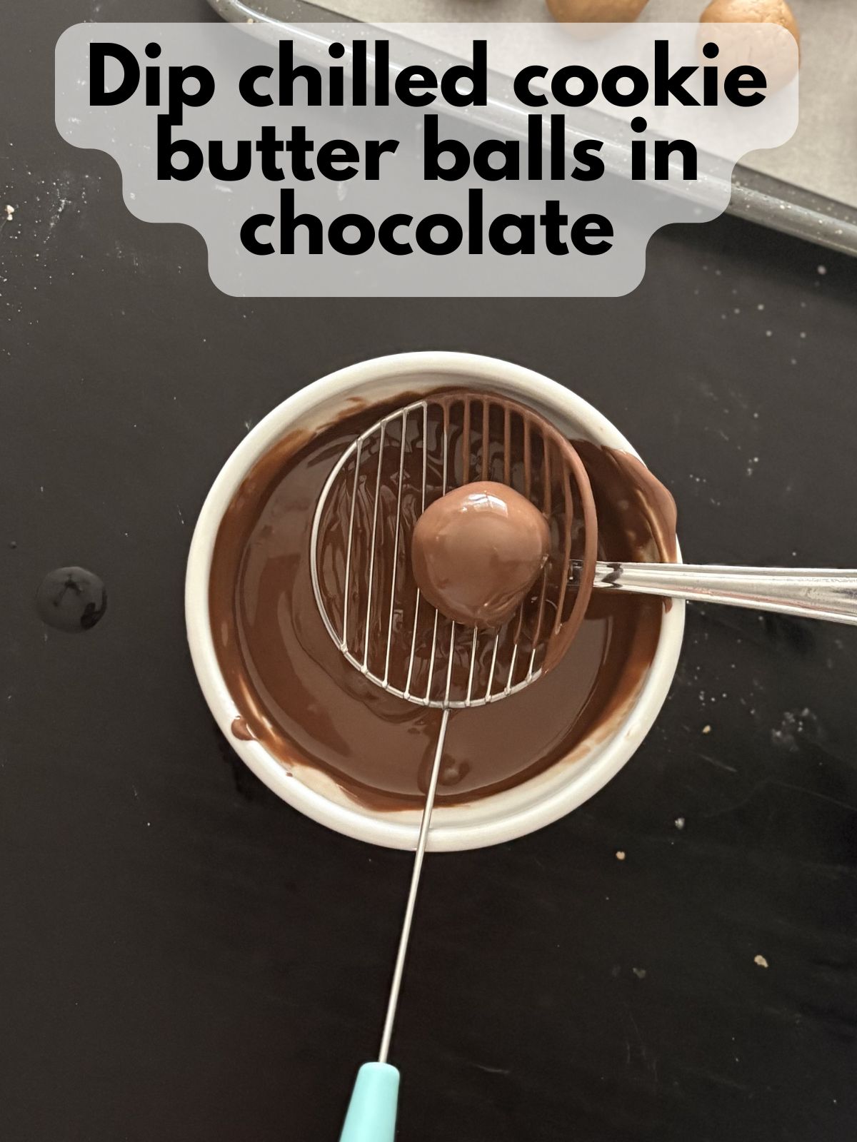 cookie butter truffle being dipped in chocolate