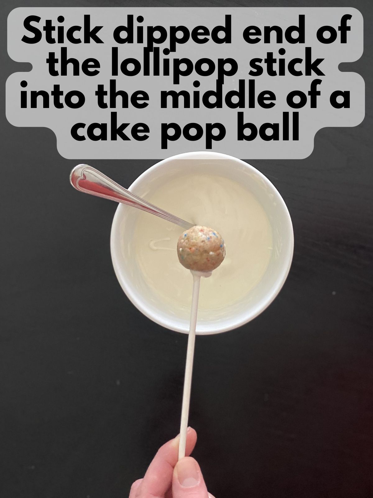 funfetti cake pop with a lollipop stick stuck in the middle