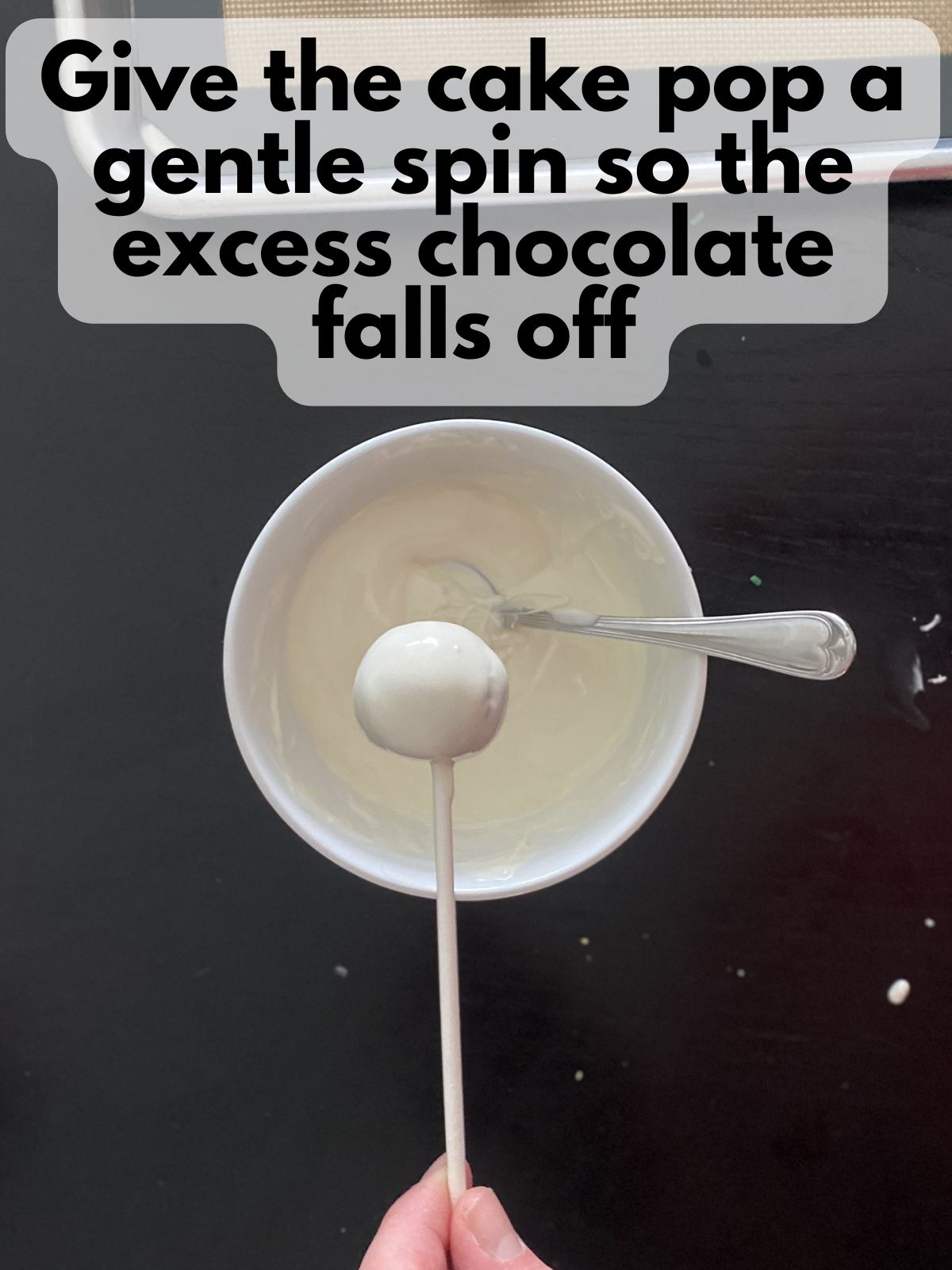 excess white chocolate dripping off funfetti cake pop
