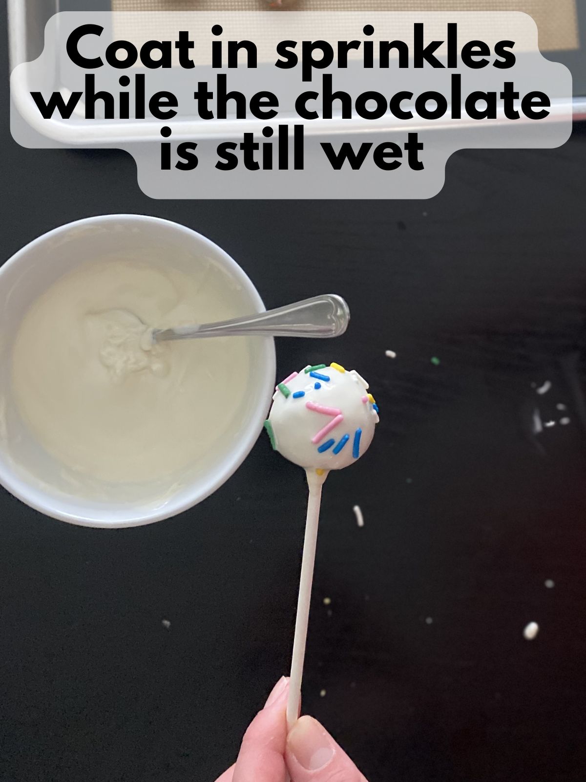 sprinkles on funfetti cake pop coated in melted white chocolate