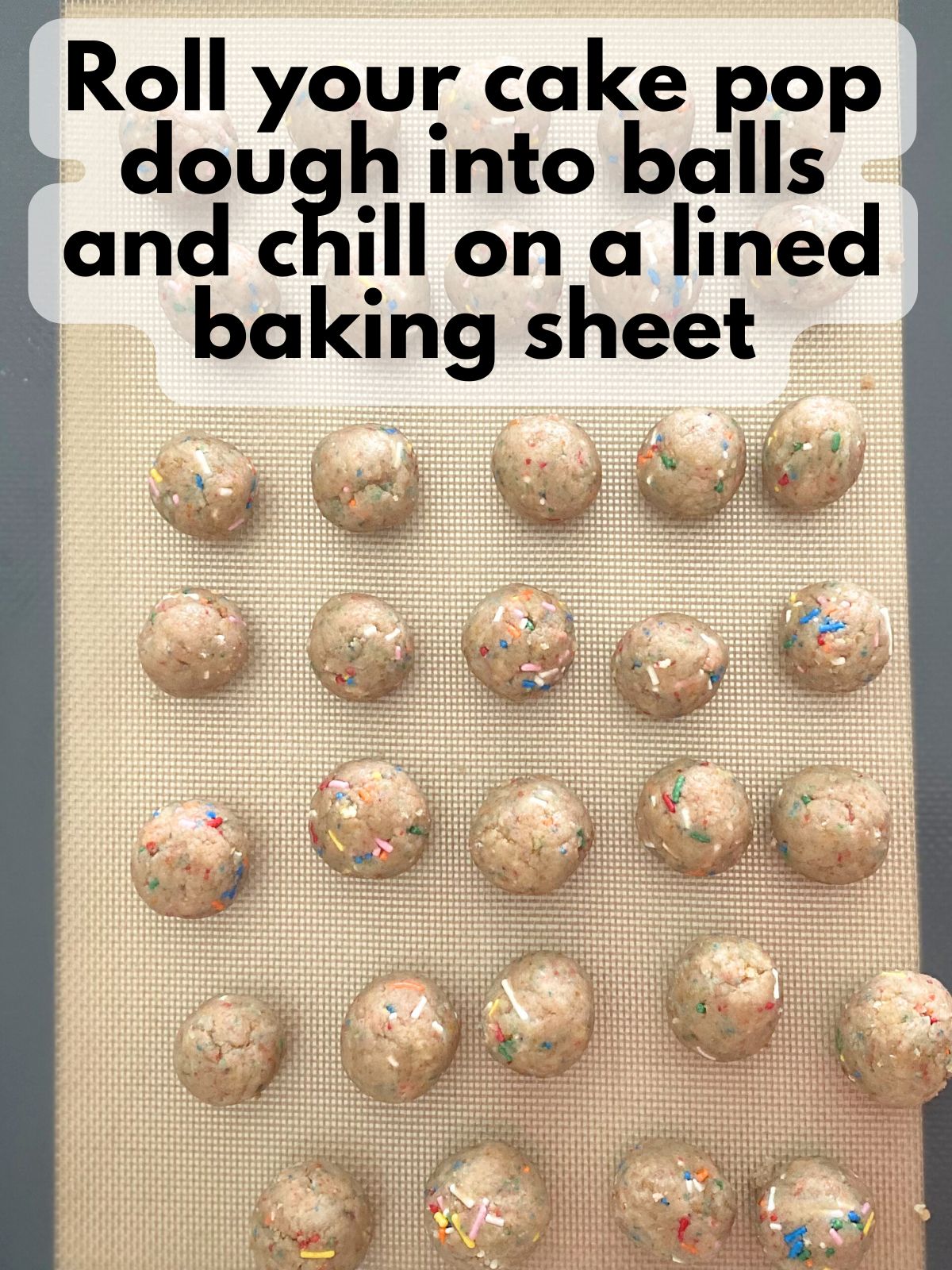funfetti cake balls on a lined baking sheet