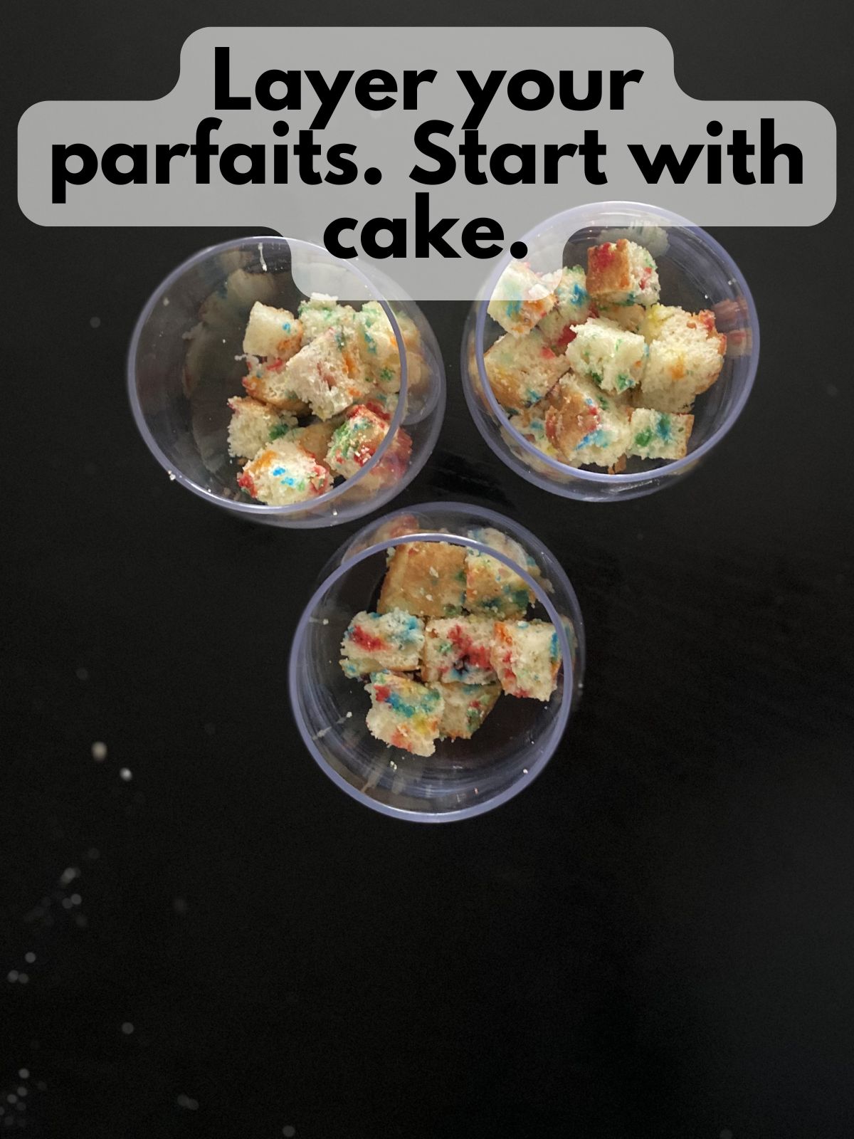 cubes of funfetti cake layered in clear glasses