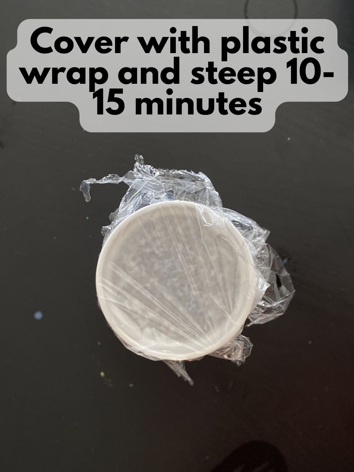 hot milk and lavender in a bowl covered in plastic wrap