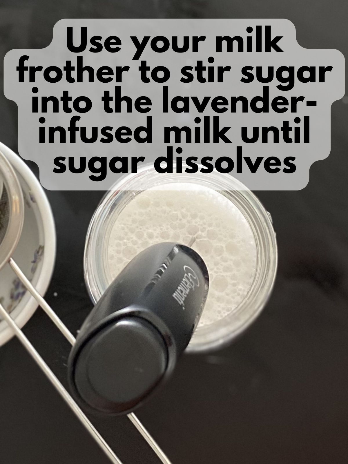 a milk frother mixing sugar into lavender-infused milk