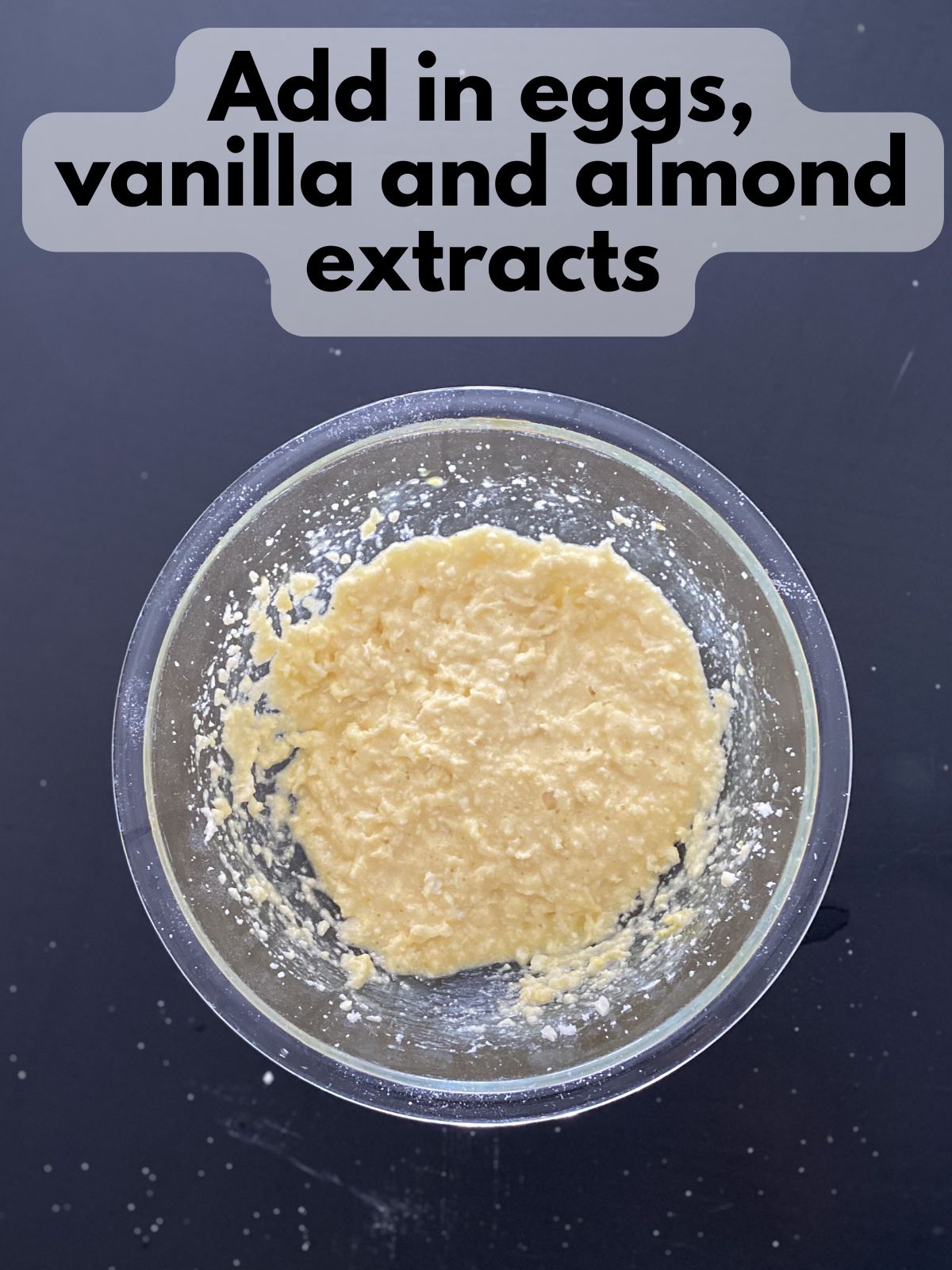 eggs, vanilla and almond extracts added to creamed butter and sugar