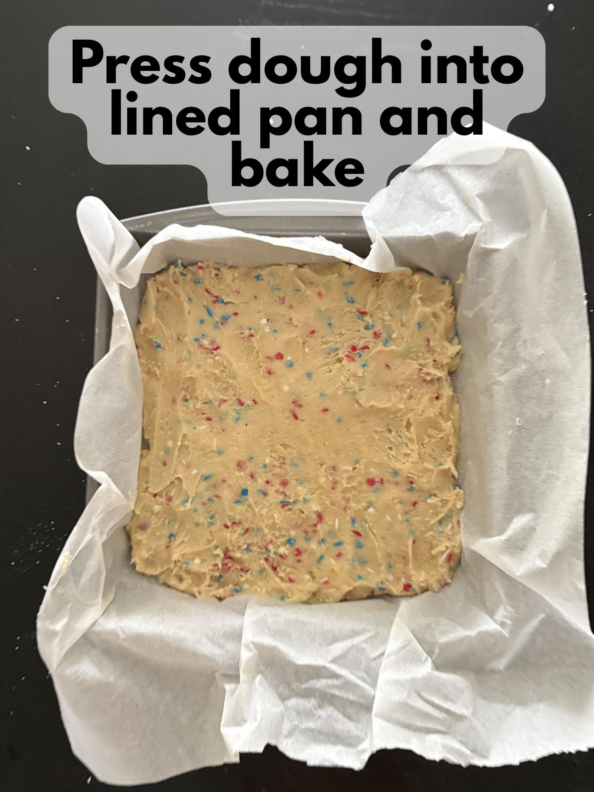 4th of July sugar cookie dough pressed into an 8x8 pan lined with parchment paper