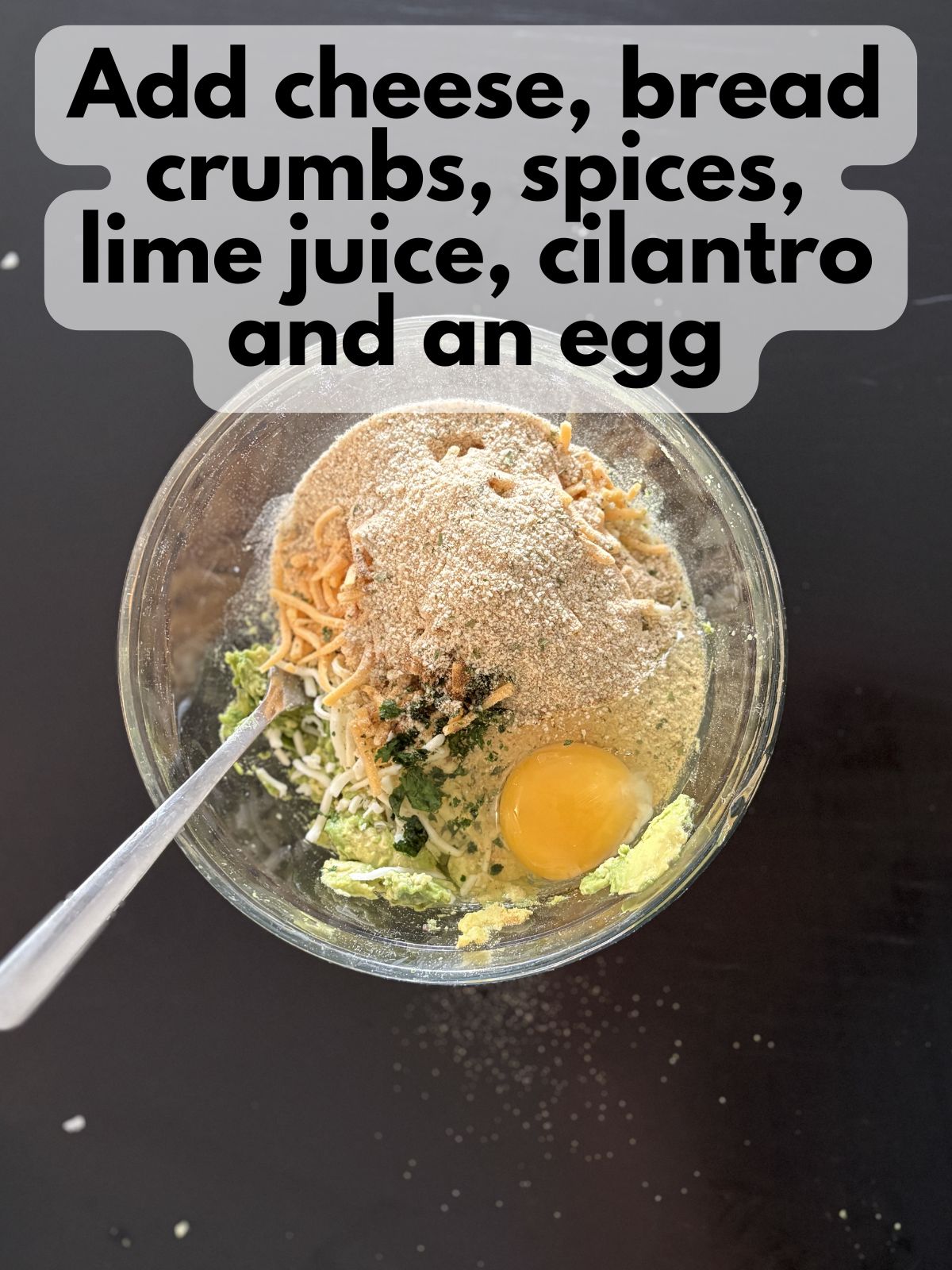 cheese, bread crumbs, spices, lime juice, cilantro and an egg in a bowl with mashed avocado