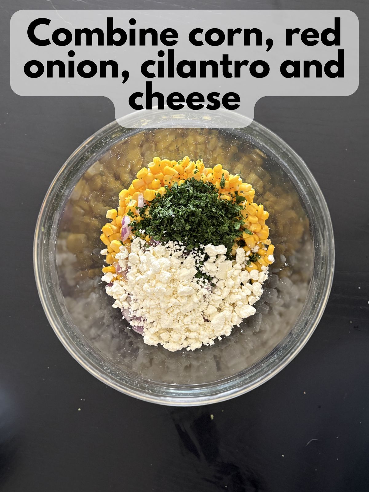 corn, red onion, cilantro and cotija cheese in a bowl