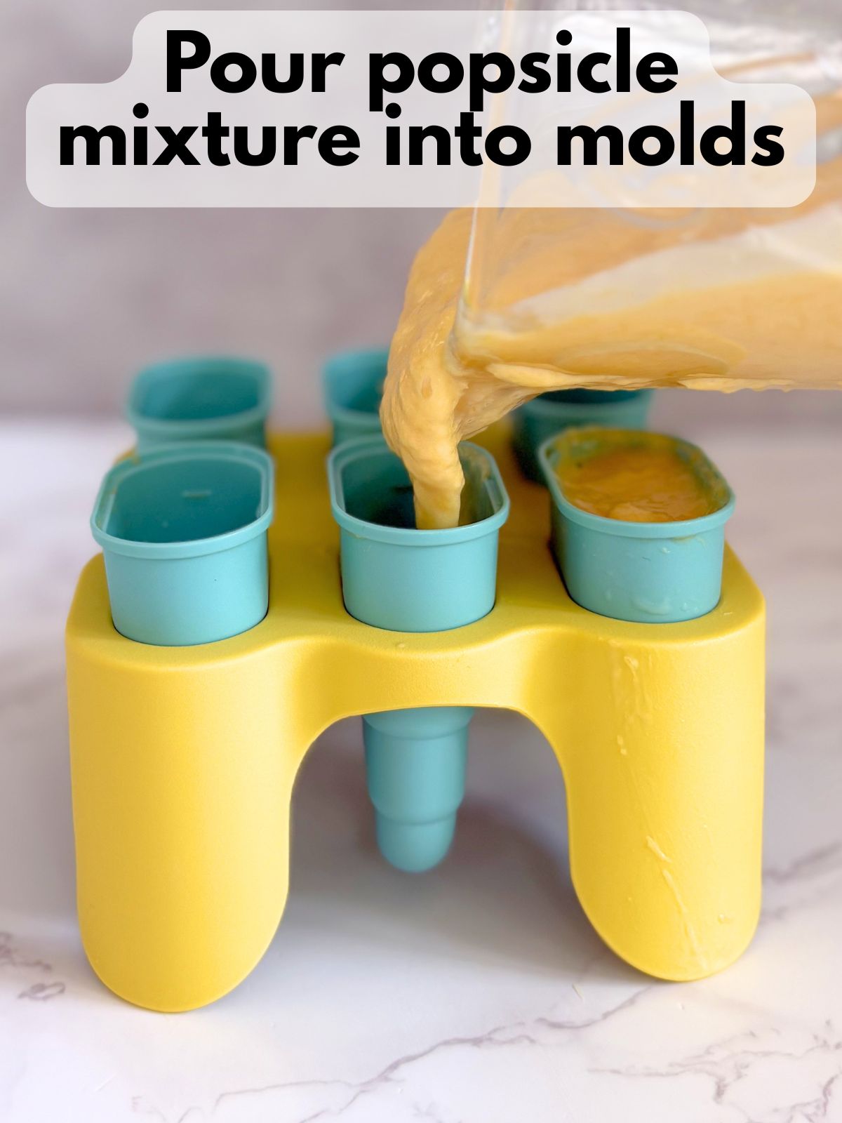 popsicle mixture being poured into popsicle molds