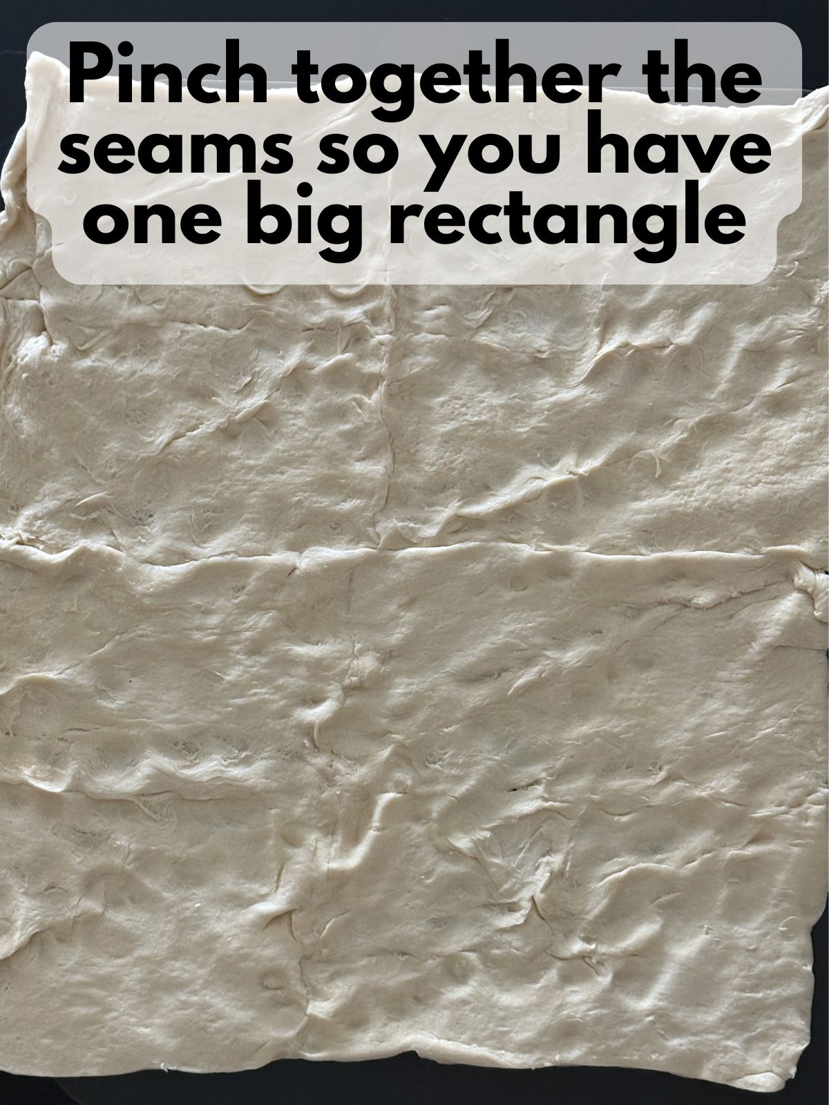 crescent roll dough pinched together into one big rectangle