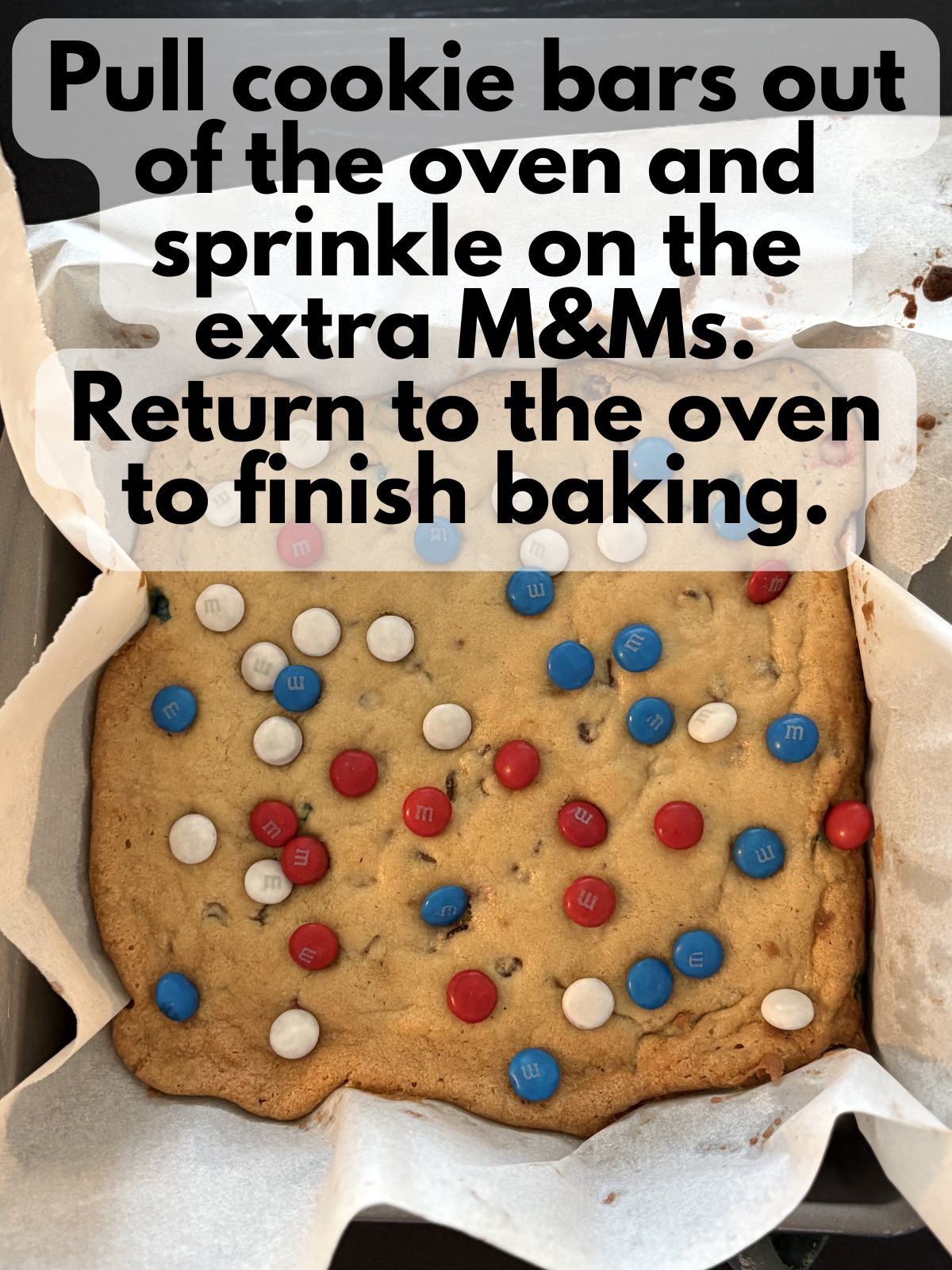 extra M&Ms sprinkled on top of par-baked cookie bars