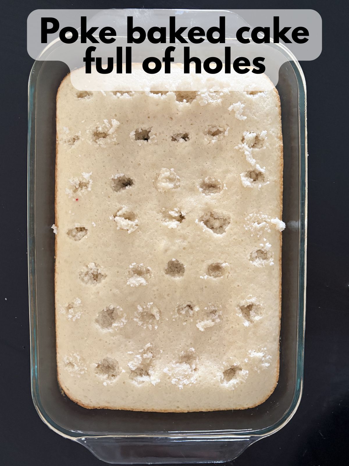 holes poked in a baked white cake