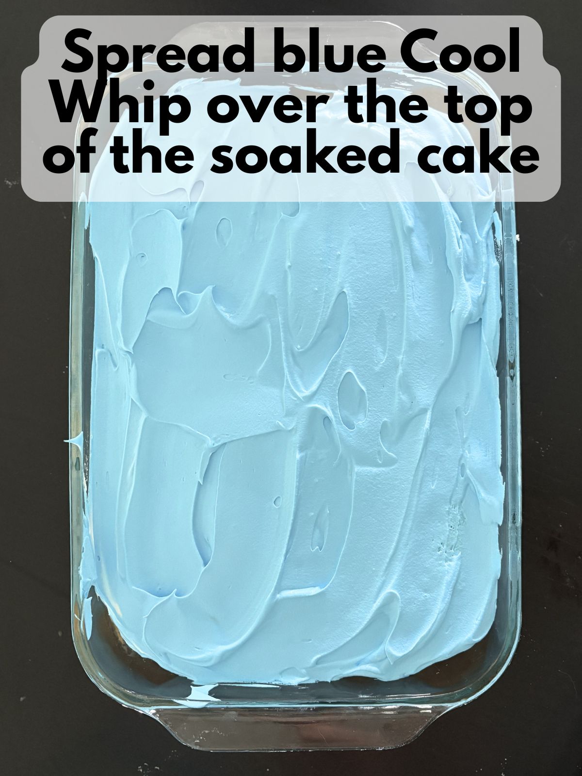 blue Cool Whip spread over top of filled cake