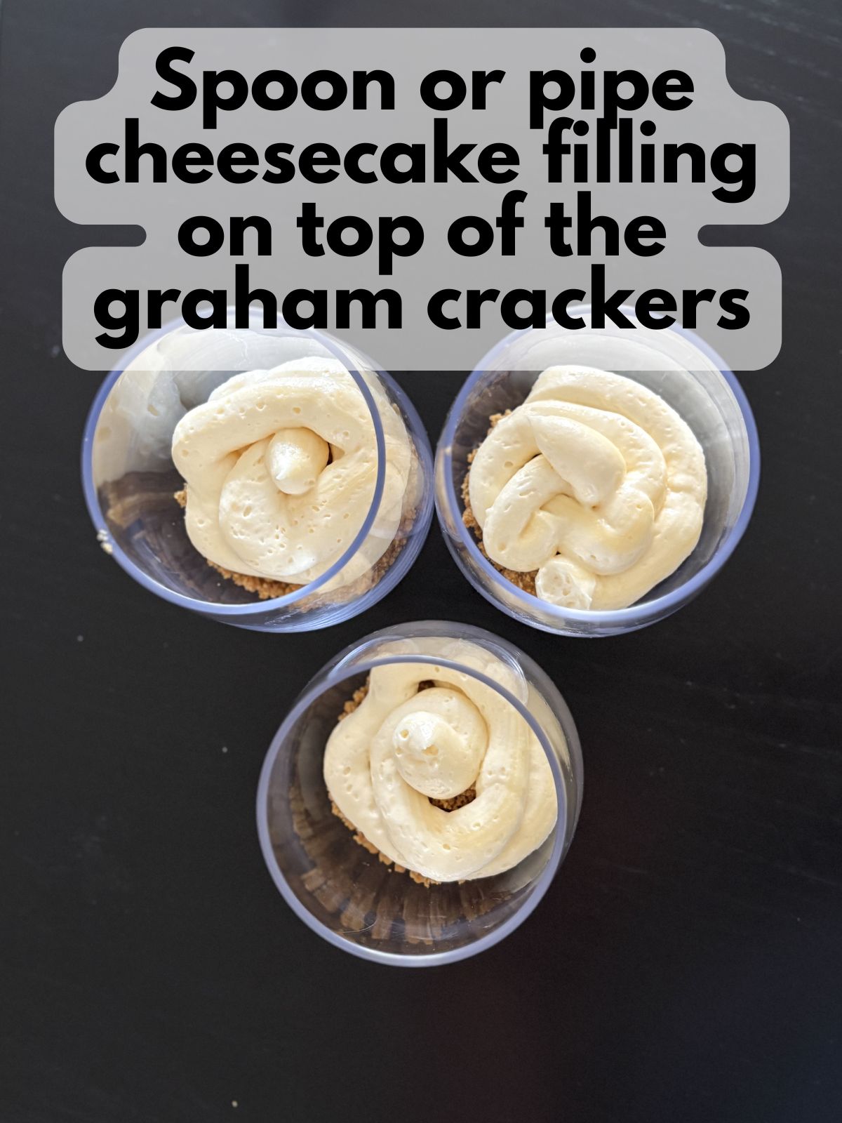 cheesecake filling piped on top of graham cracker crust