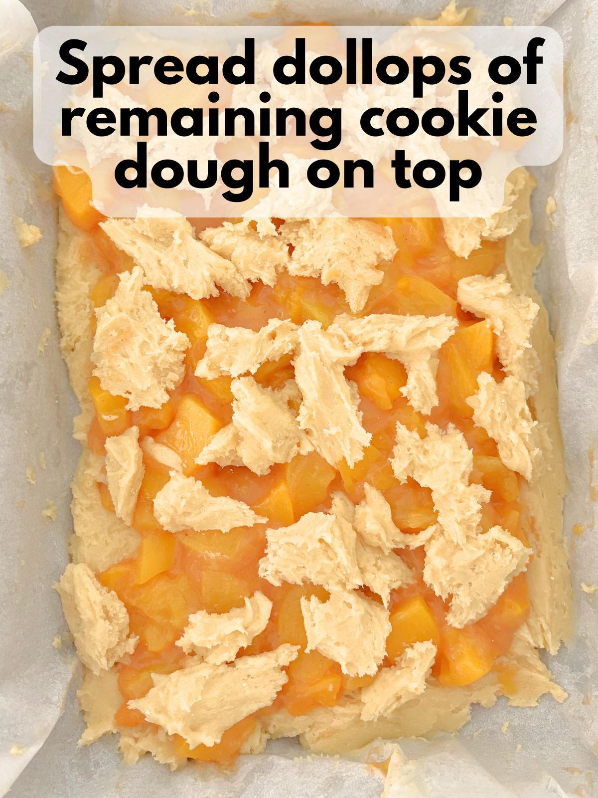 extra cookie dough dolloped on top of peach pie filling