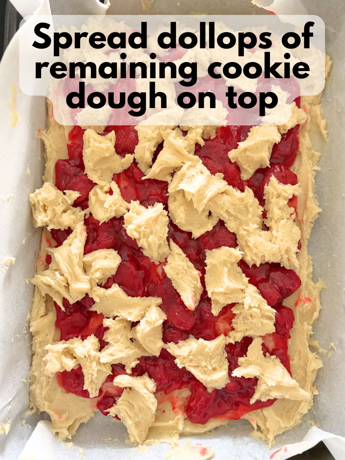 sugar cookie dough dolloped on top of strawberry pie filling
