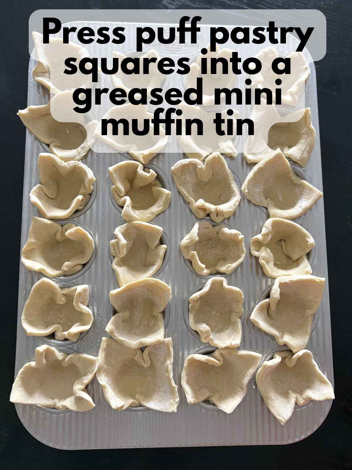 puff pastry squares pushed into a mini muffin tin