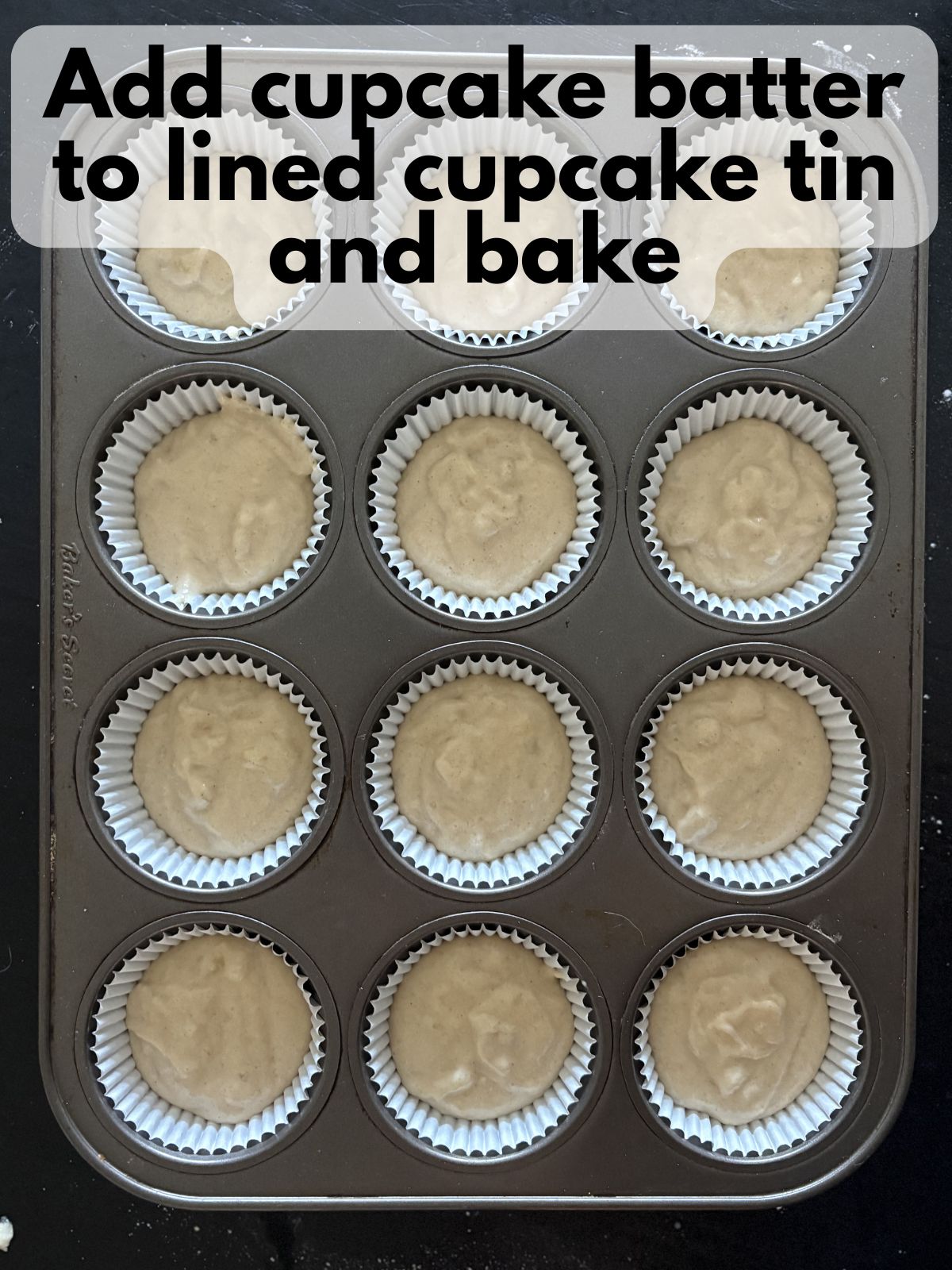 banana cupcake batter poured into lined cupcake tins