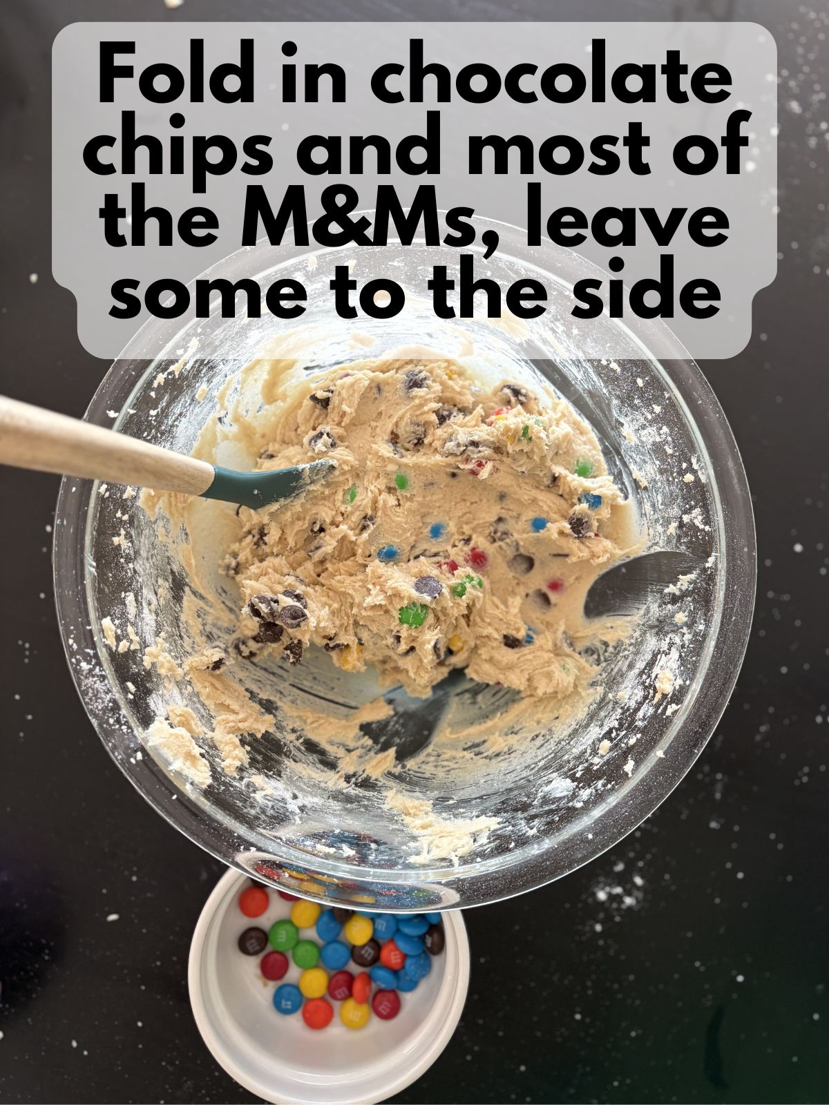 M&Ms and chocolate chips folded into cookie dough, some M&Ms kept apart