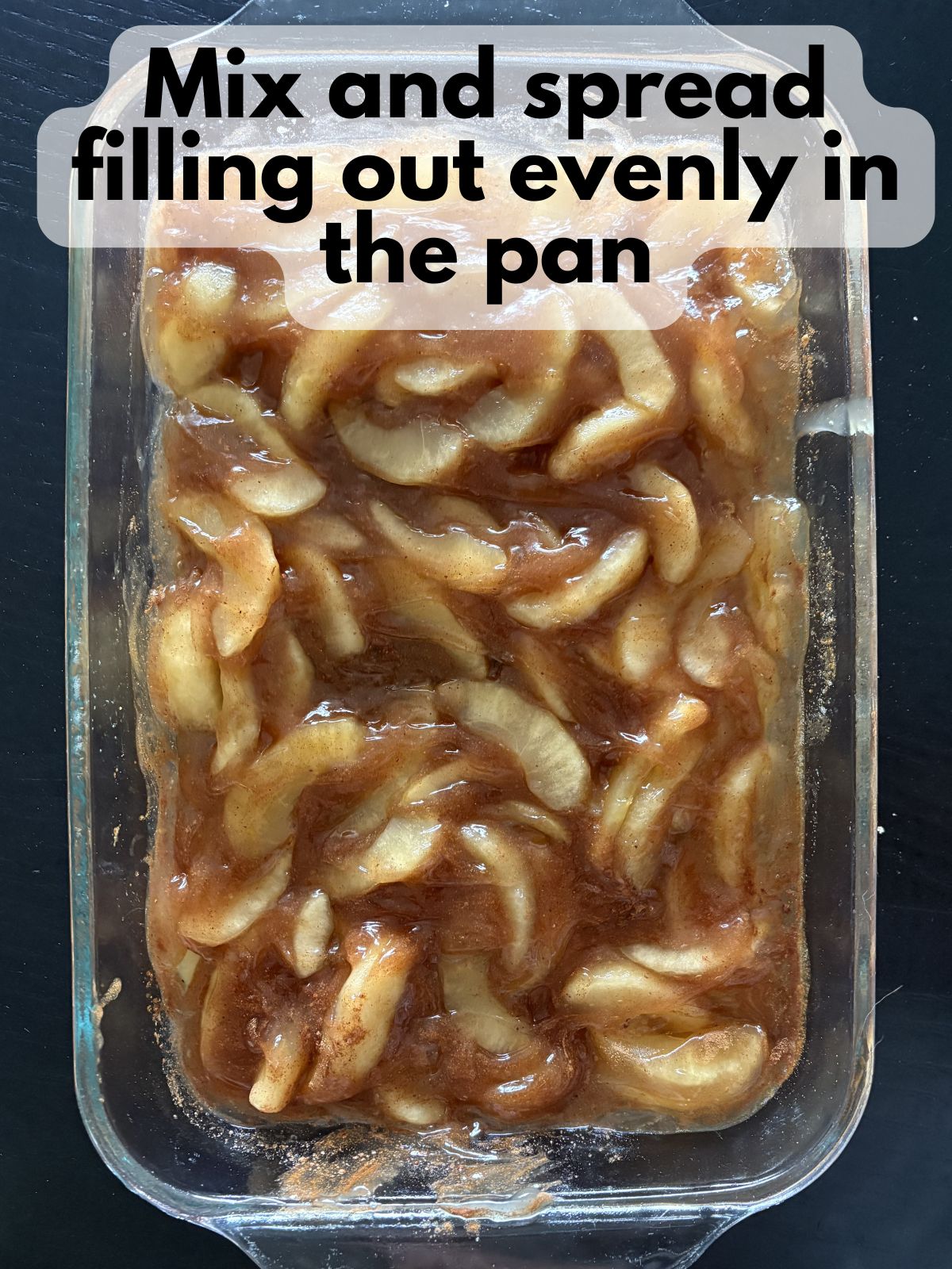 apple pie filling mixed with spices, vanilla and lemon juice, spread in a 9x13 baking dish