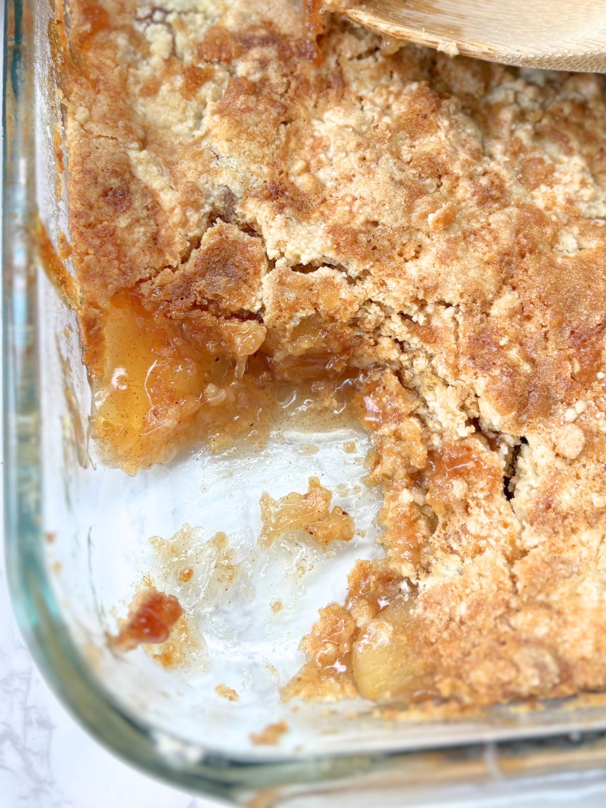 cake mix apple cobbler with a slice taken out of it