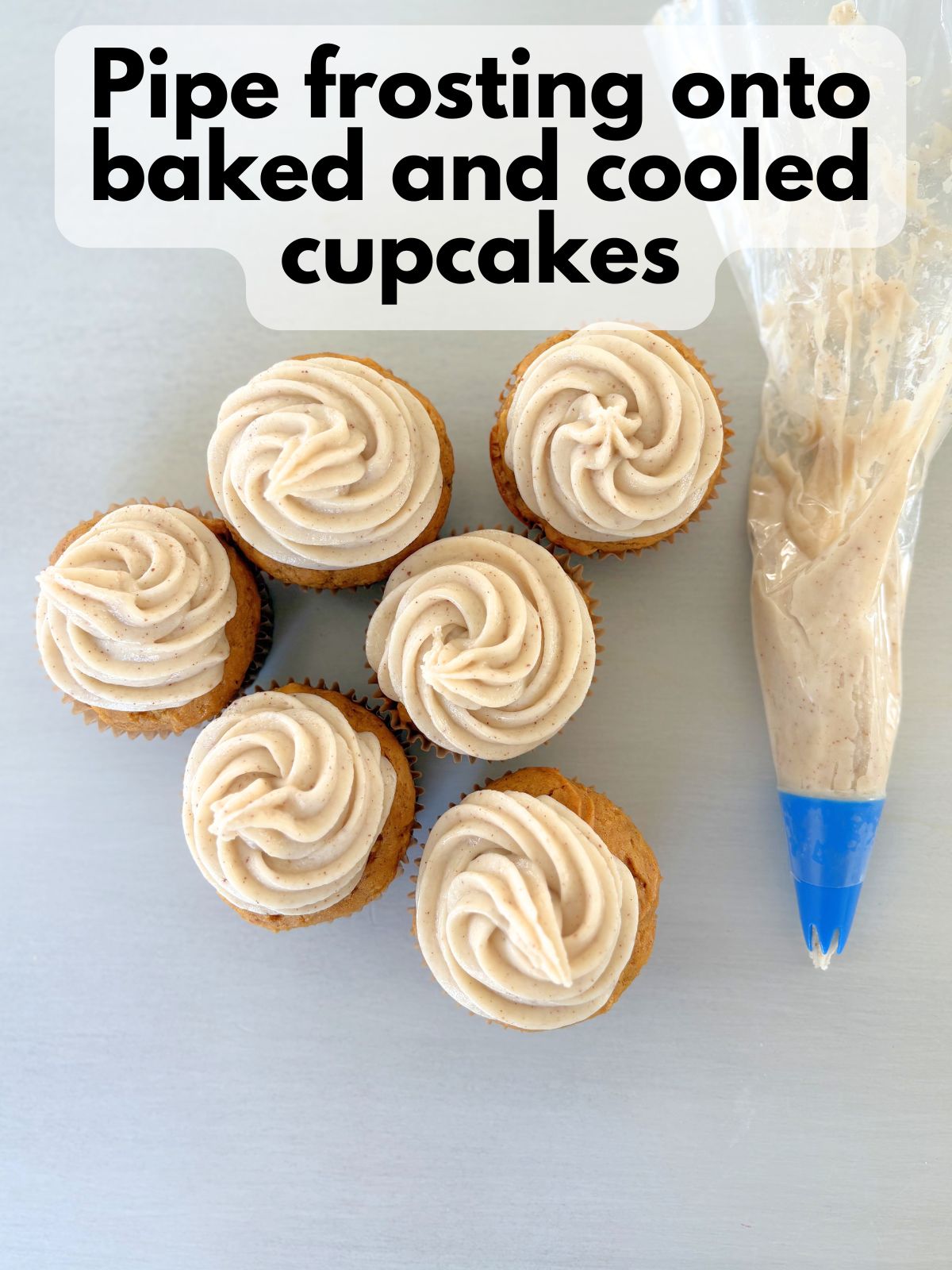 brown butter maple frosting piped on top of gluten free pumpkin cupcakes
