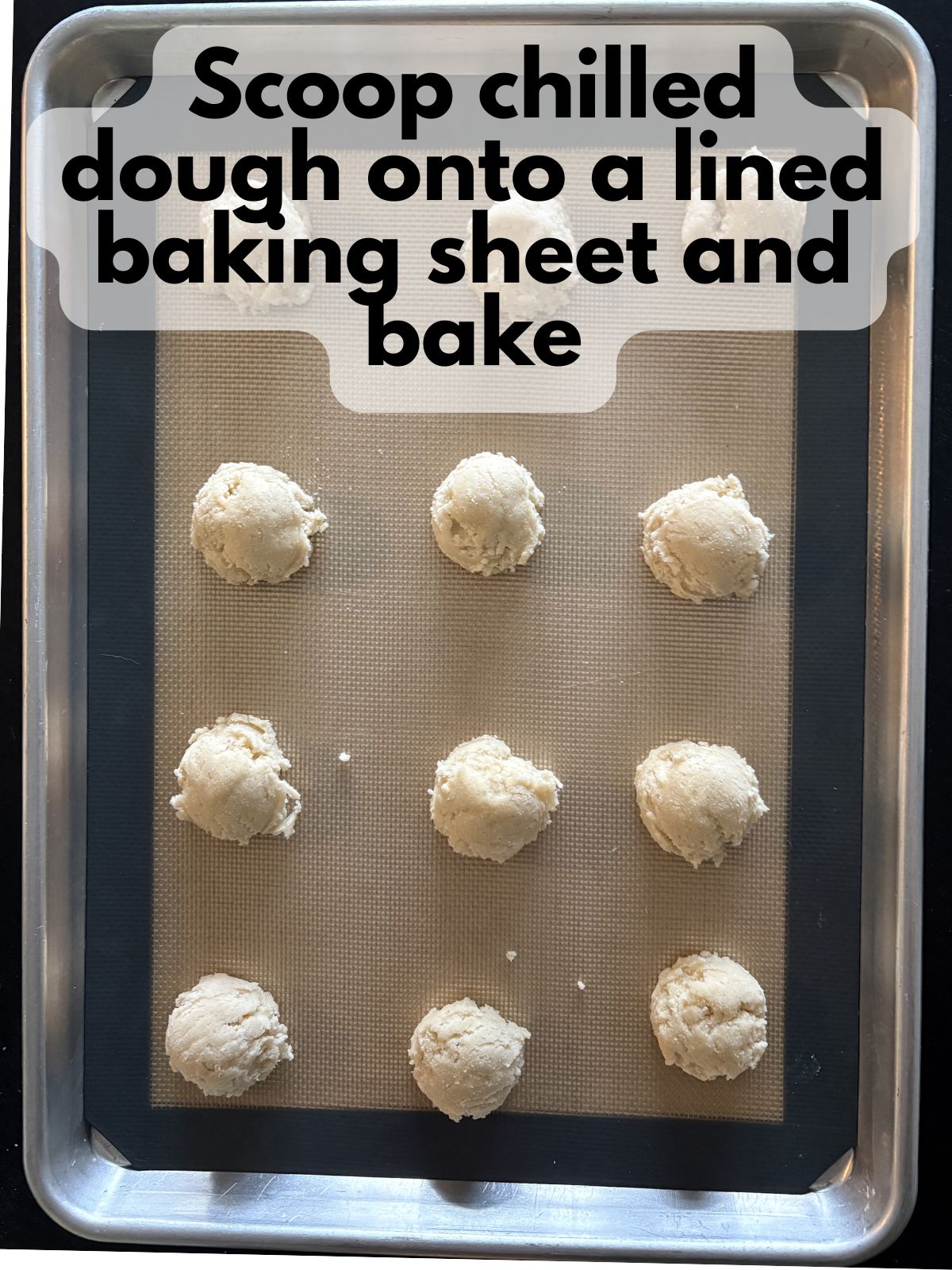 sugar cookie scooped on a baking sheet