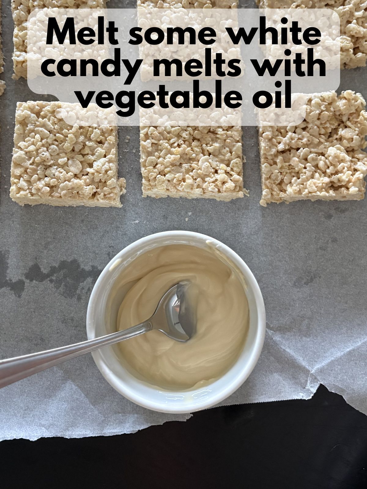 melted white chocolate in a bowl next to some rice krispie treats