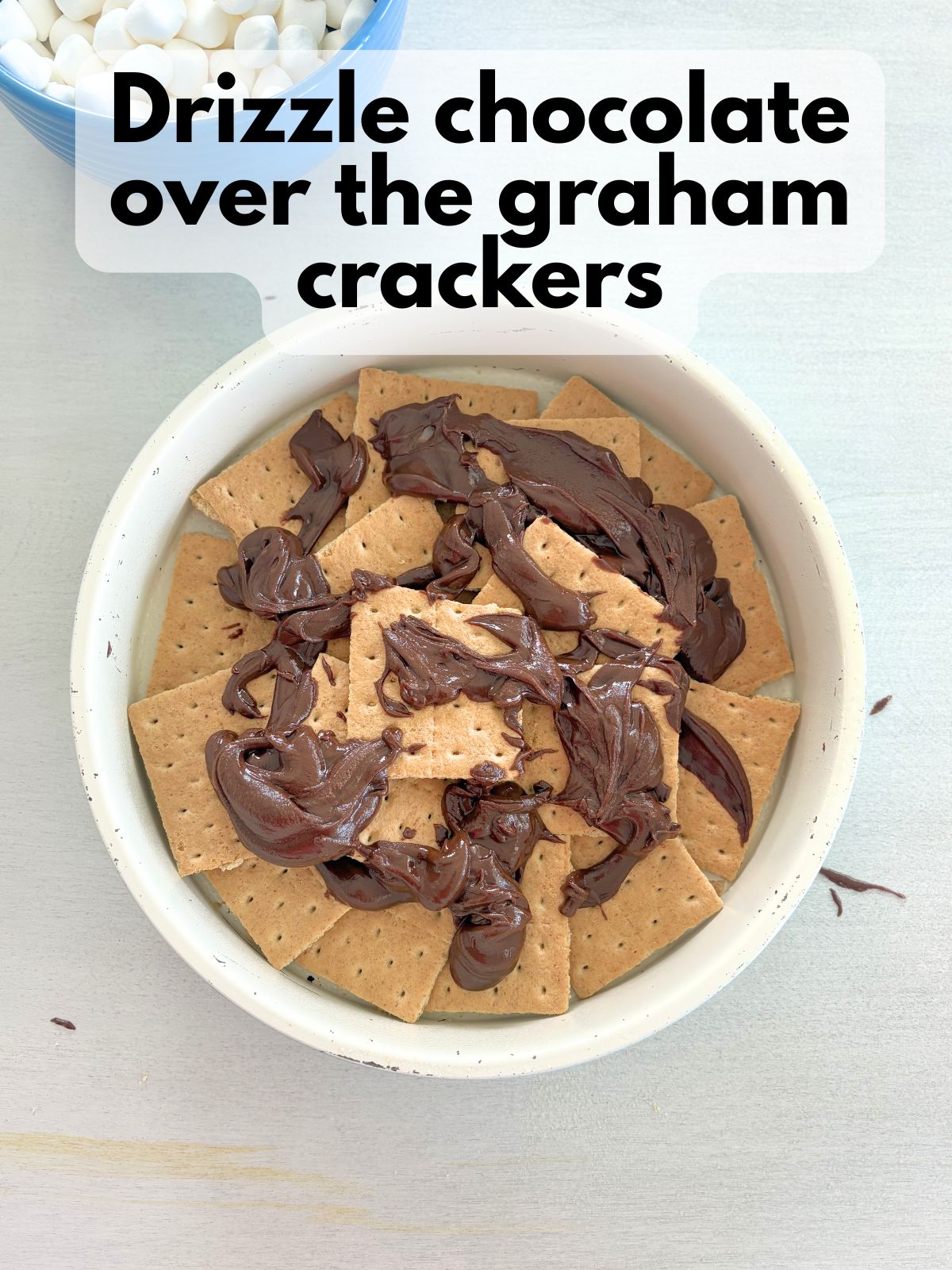 chocolate spread over graham crackers in a round pan