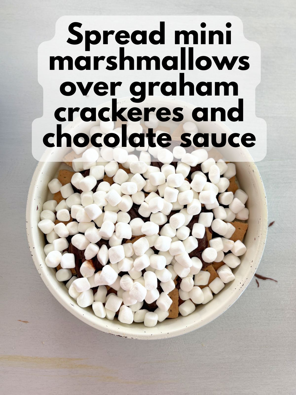 mini marshmallows spread over graham crackers and chocolate