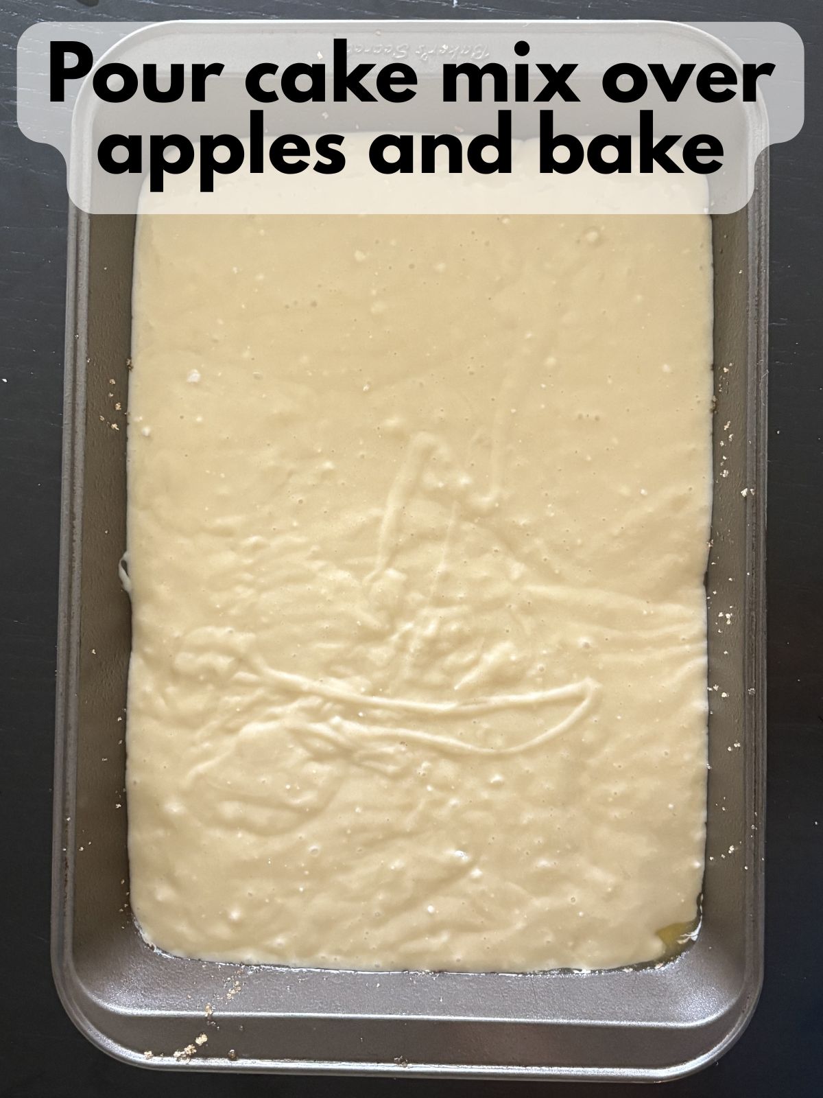 yellow cake batter poured on top of brown sugar and apples