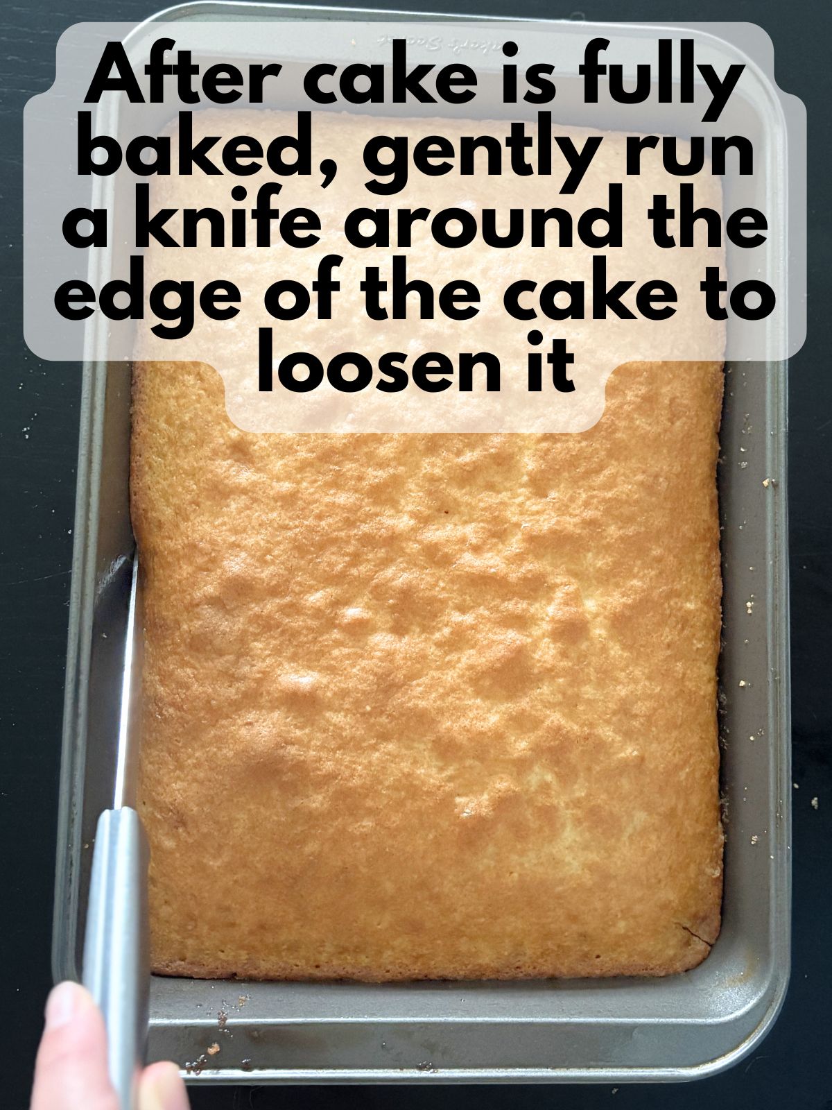 a knife running along the edges of a baked cake