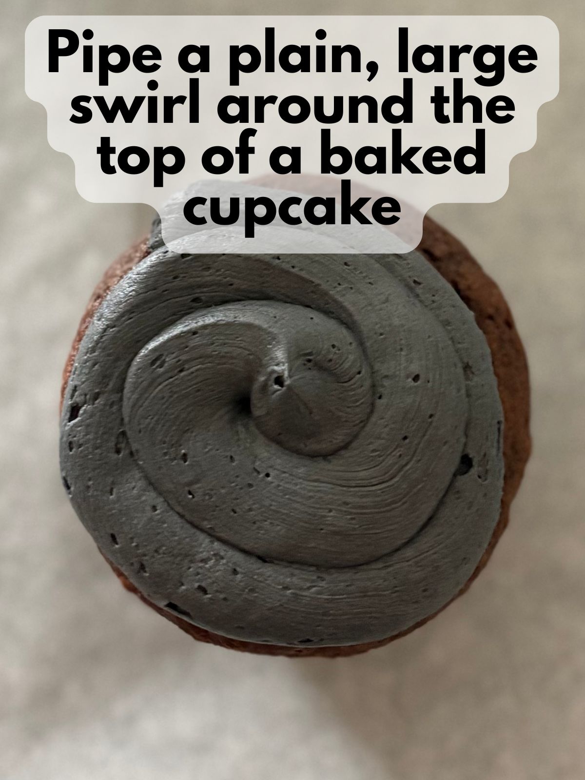 chocolate cupcake with black frosting piped on top of it
