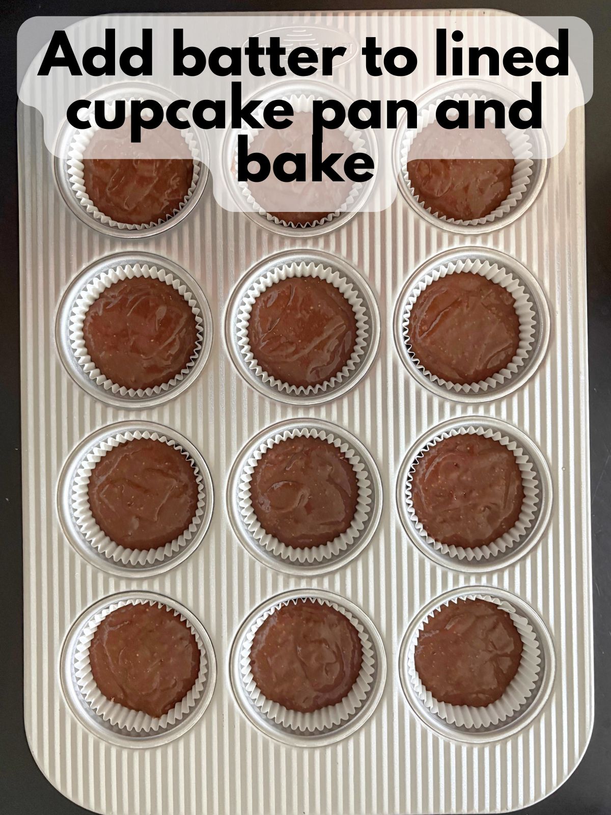 chocolate cupcake batter in a lined cupcake pan