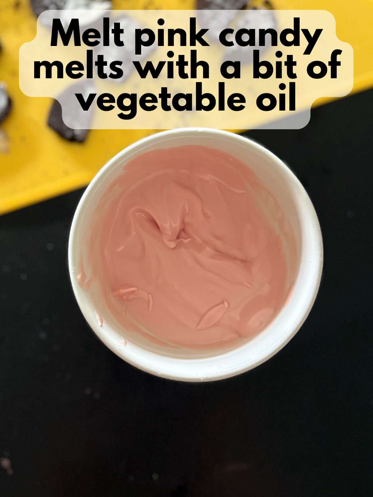 pink candy melts melted with vegetable oil in a bowl