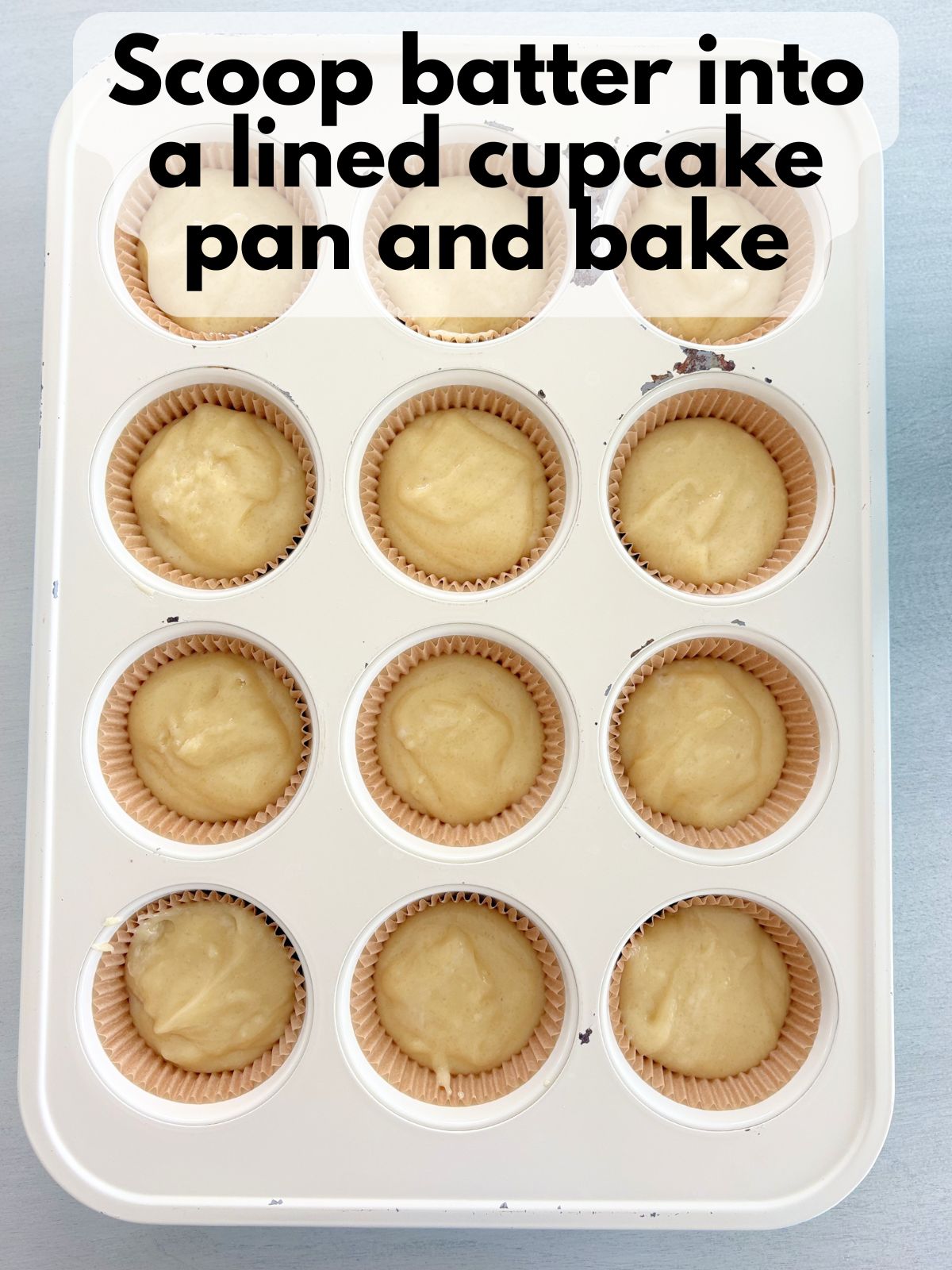 gluten free yellow cupcake batter in a lined cupcake pan