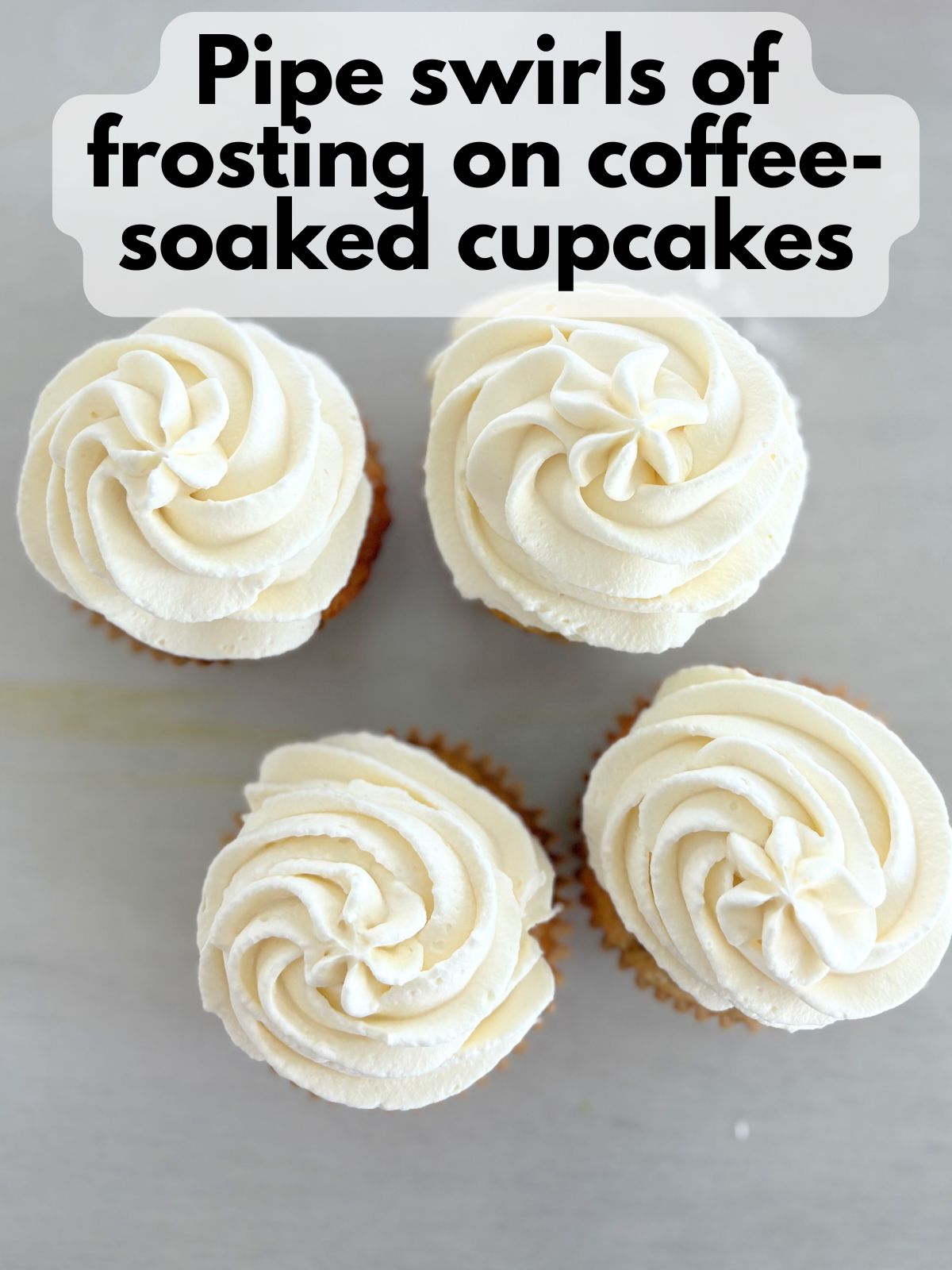 mascarpone frosting piped on top of coffee-soaked gluten free tiramisu cupcakes