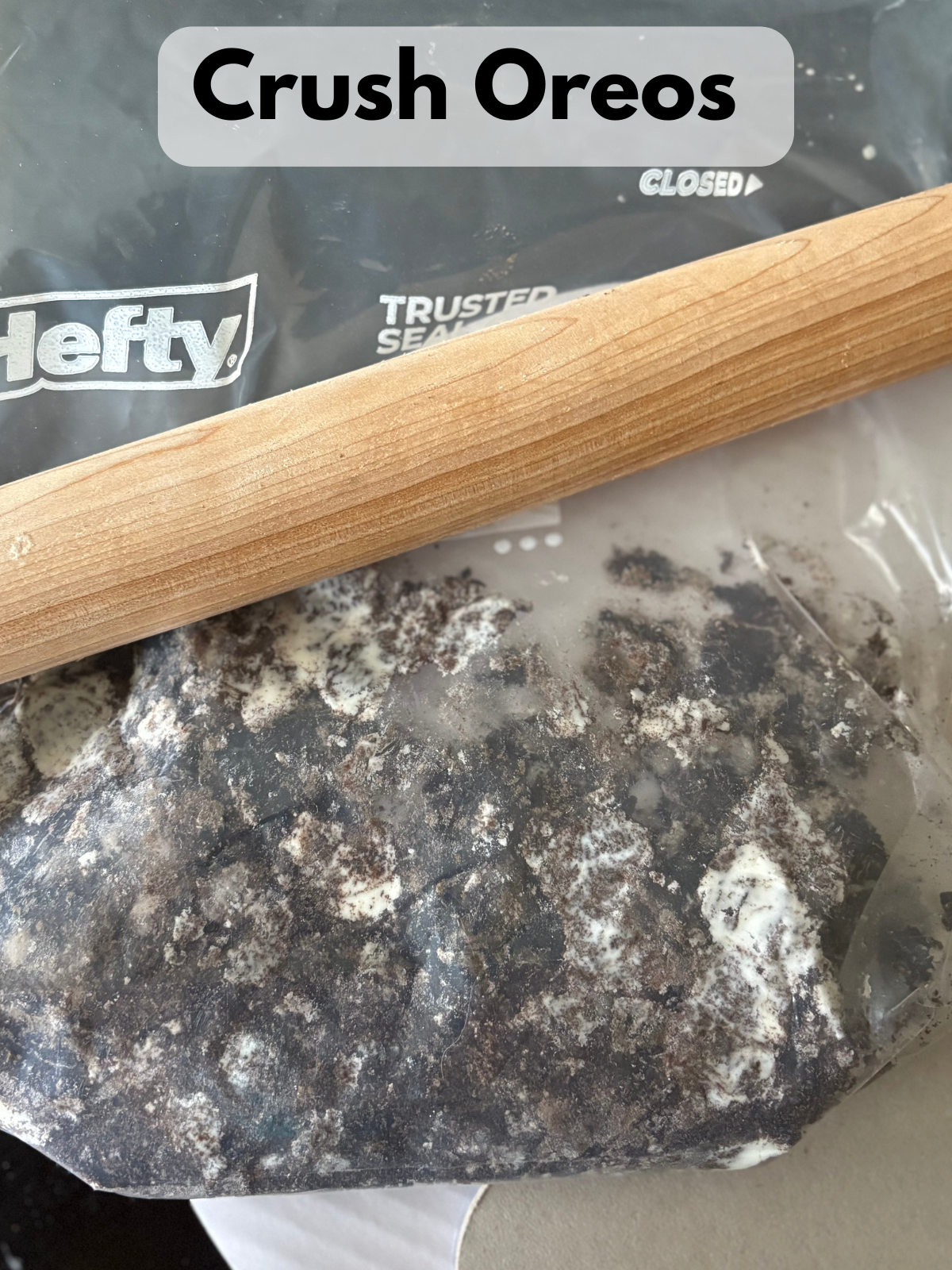 crushed Oreos in a bag, laying next to a rolling pin