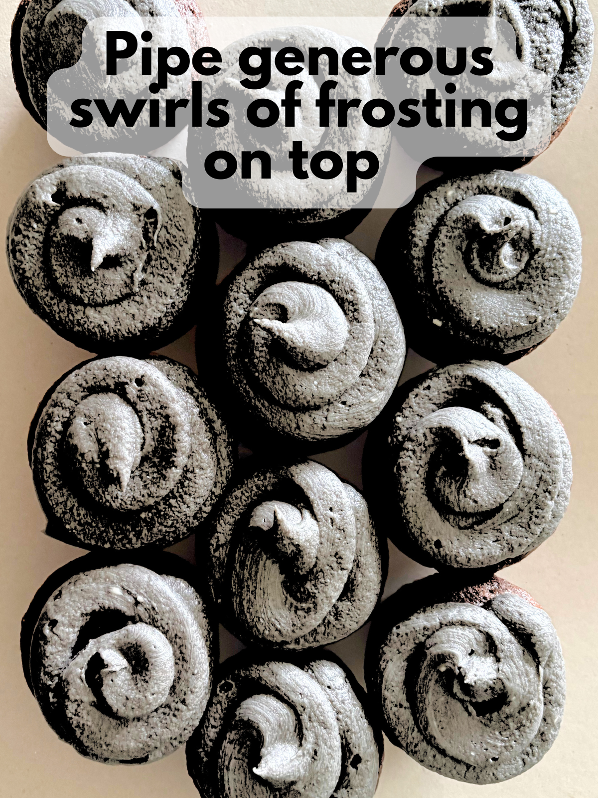 black buttercream frosting swirled on top of cupcakes