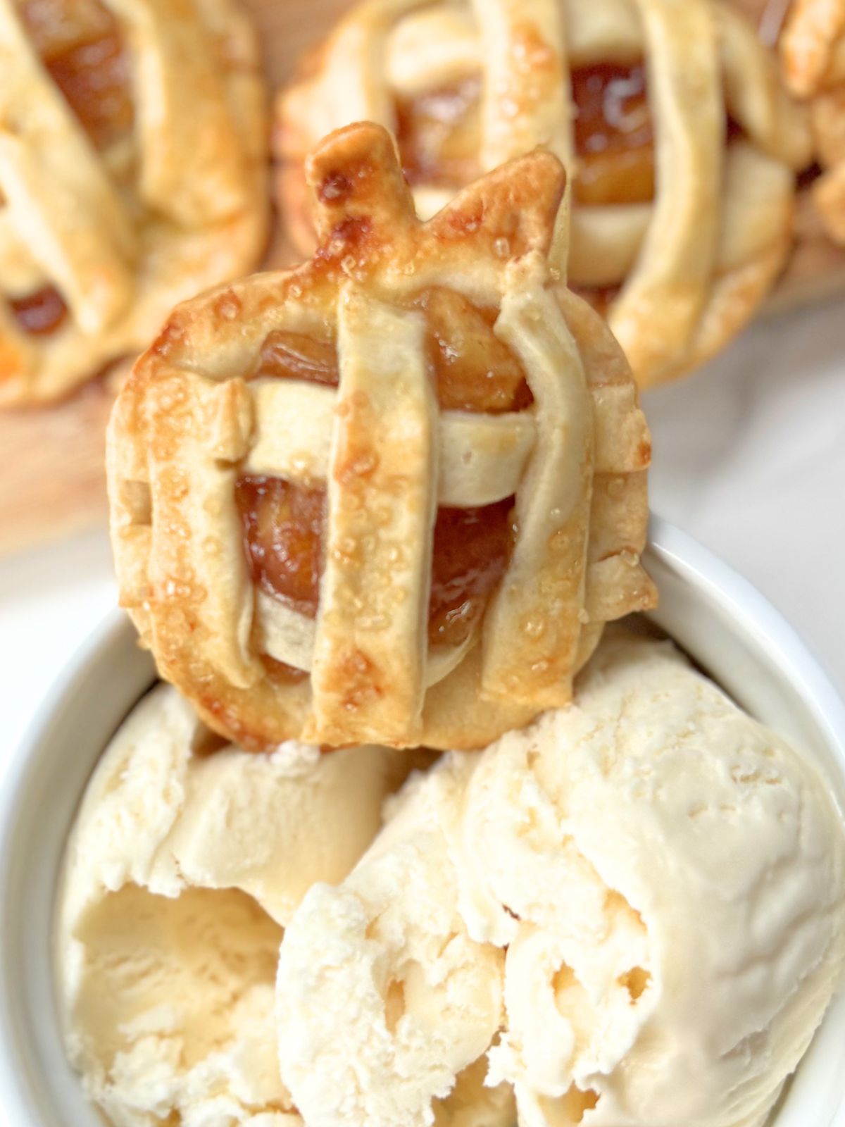 a mini apple pie sitting in a bowl of ice cream