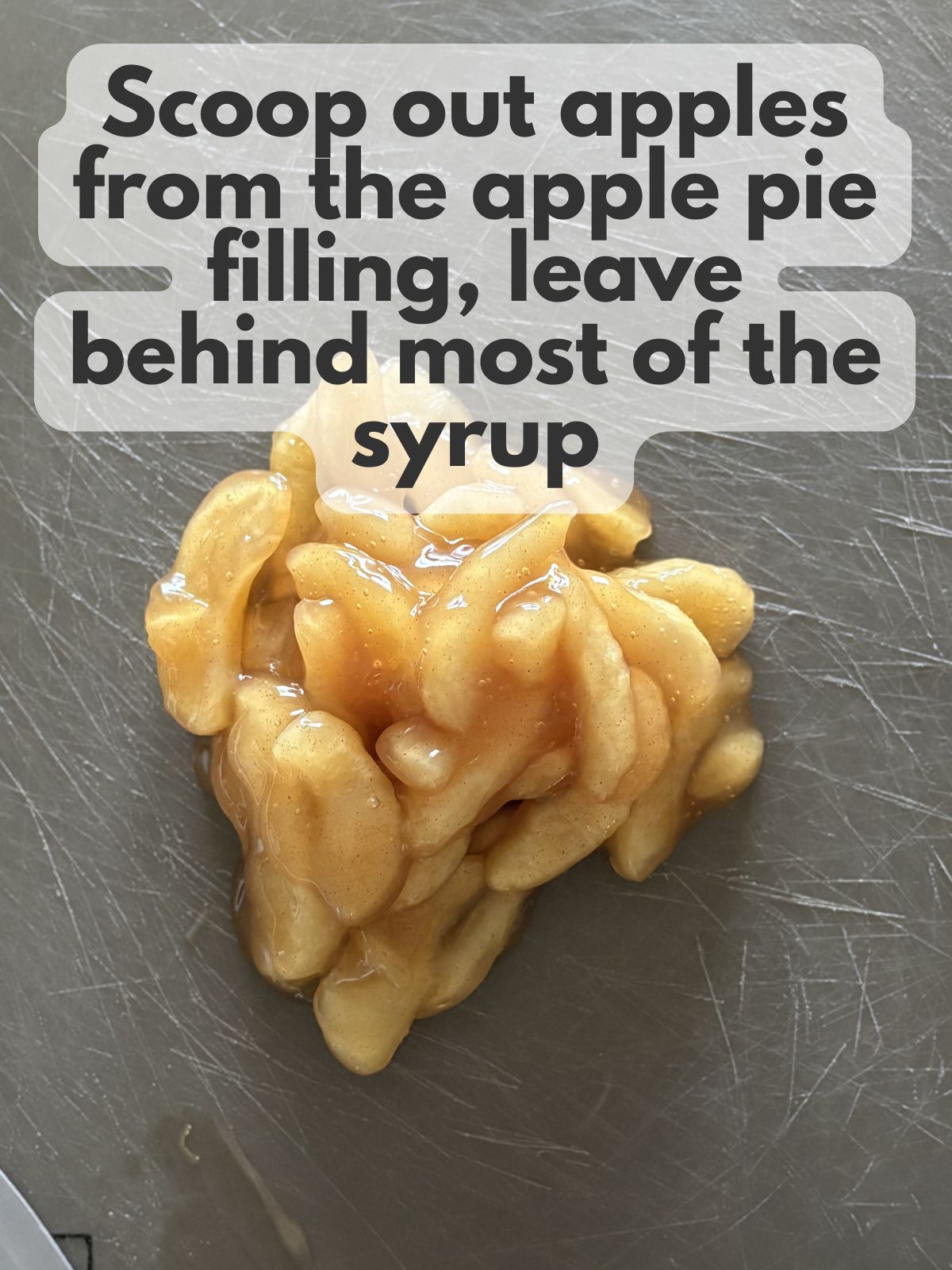 apple pie filling on a cutting board, most of the syrup has been drained away