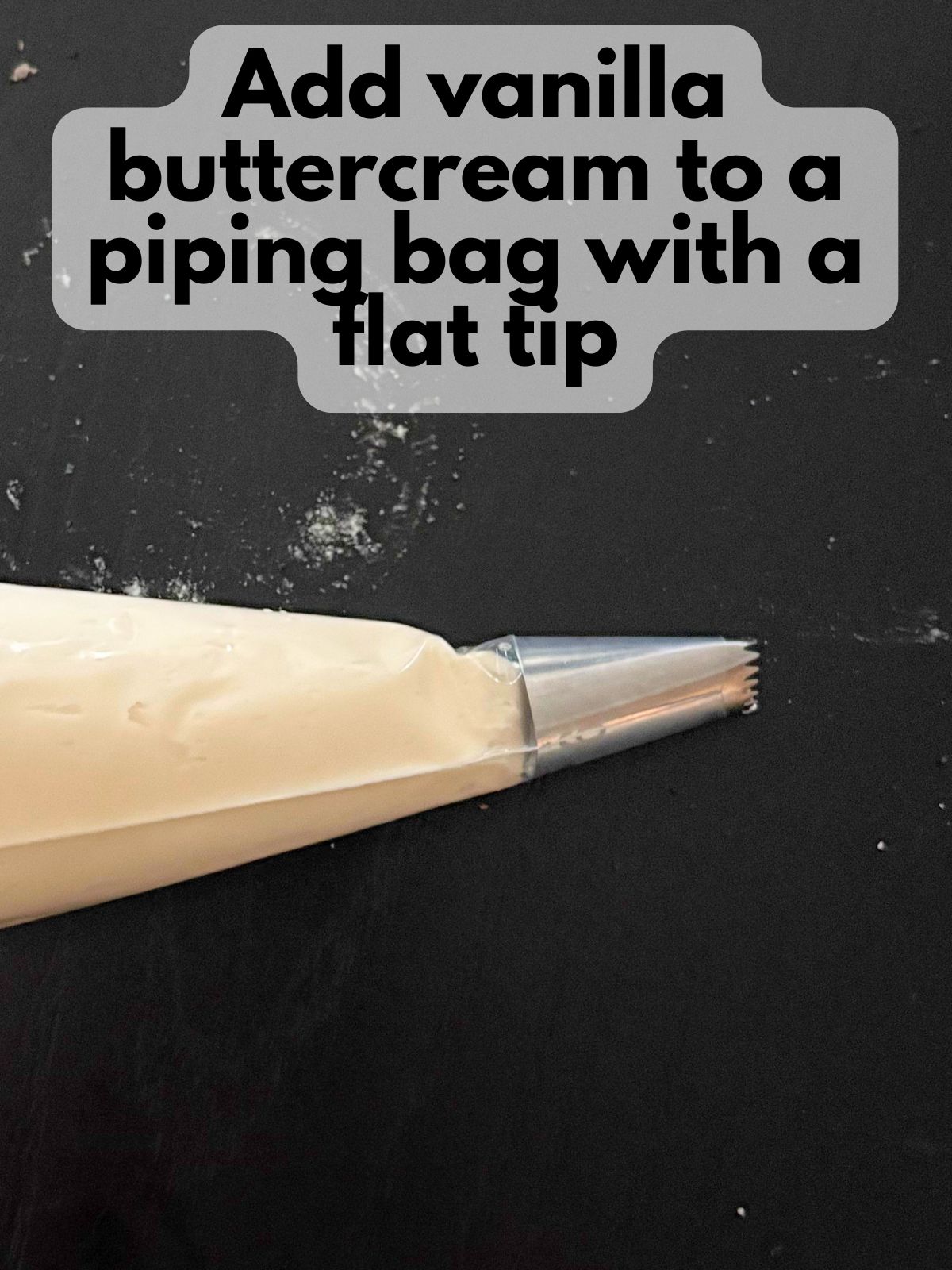 vanilla buttercream in a piping bag with a flat tip
