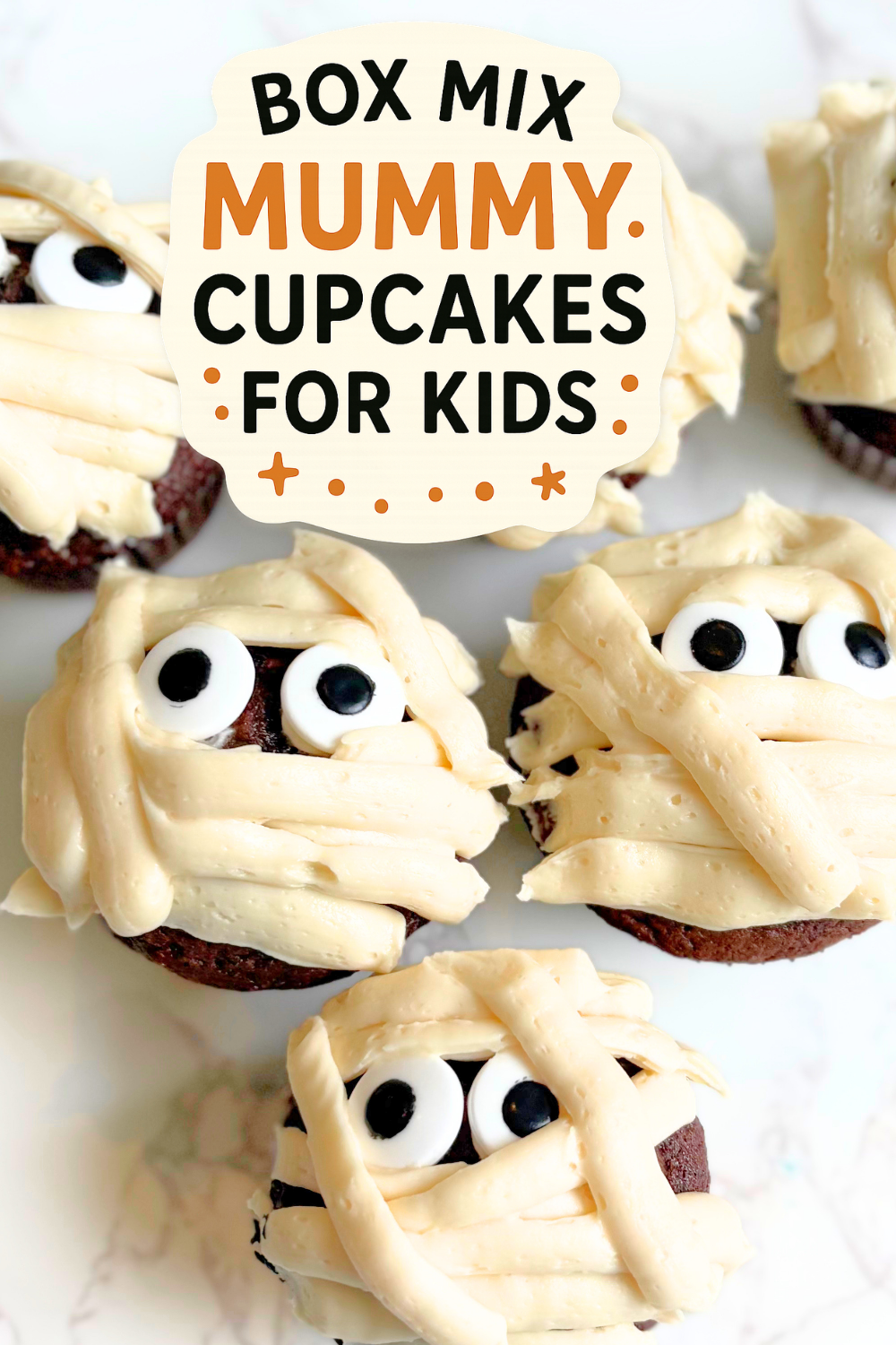 Turn a simple chocolate cake mix into adorable Box Mix Mummy Cupcakes; rich coffee enhanced cupcakes topped with fluffy vanilla buttercream, piped mummy “bandages,” and candy eyes for the easiest Halloween cupcake recipe busy bakers will love.