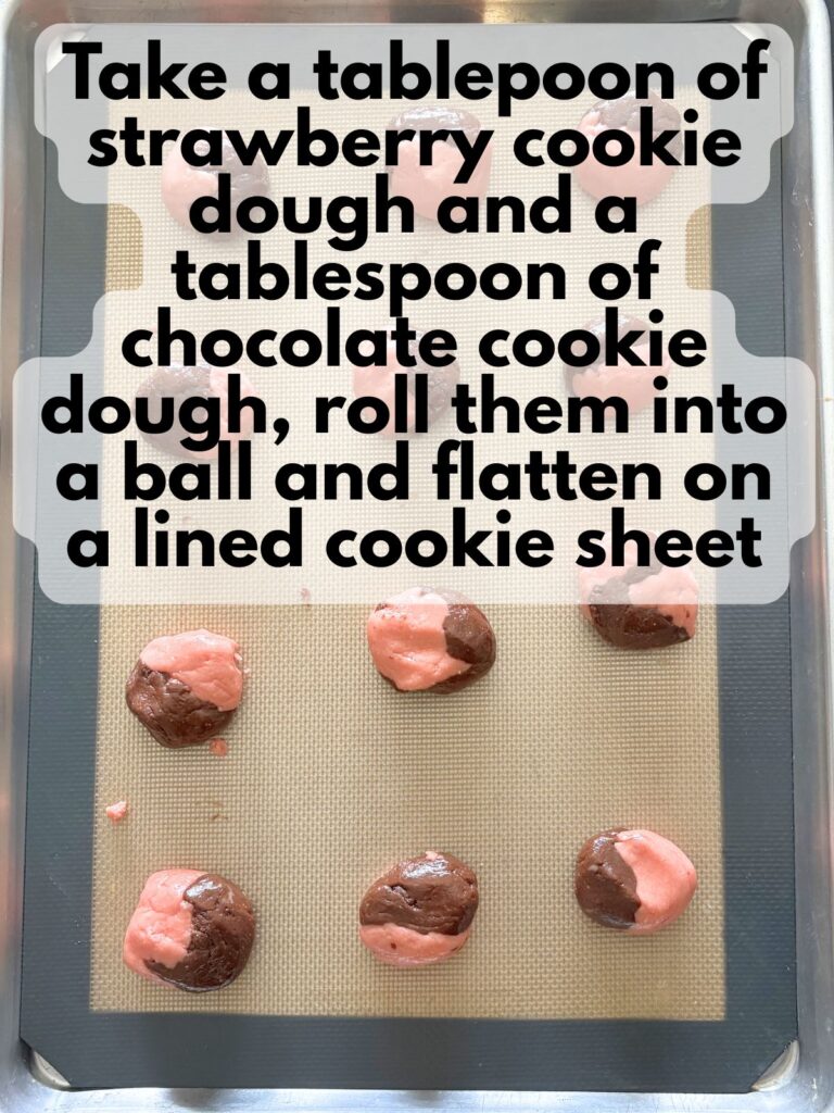 strawberry and chocolate cake mix cookie dough rolled together in balls on a lined baking sheet