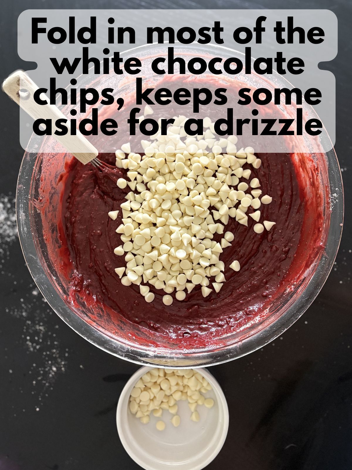 white chocolate chips mixed with red velvet brownie batter, some white chocolate chips are kept apart in a bowl